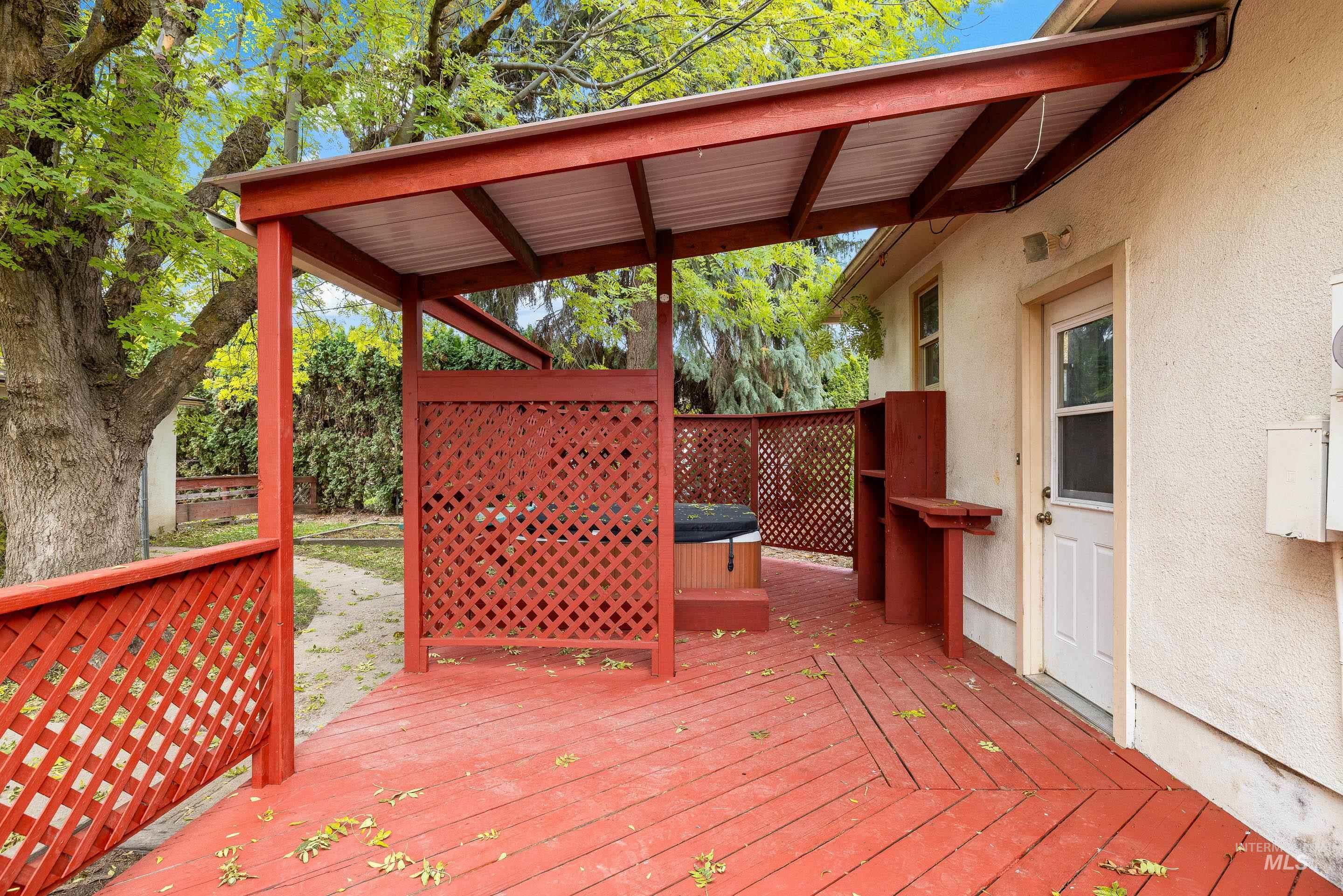 Wooden terrace featuring a hot tub