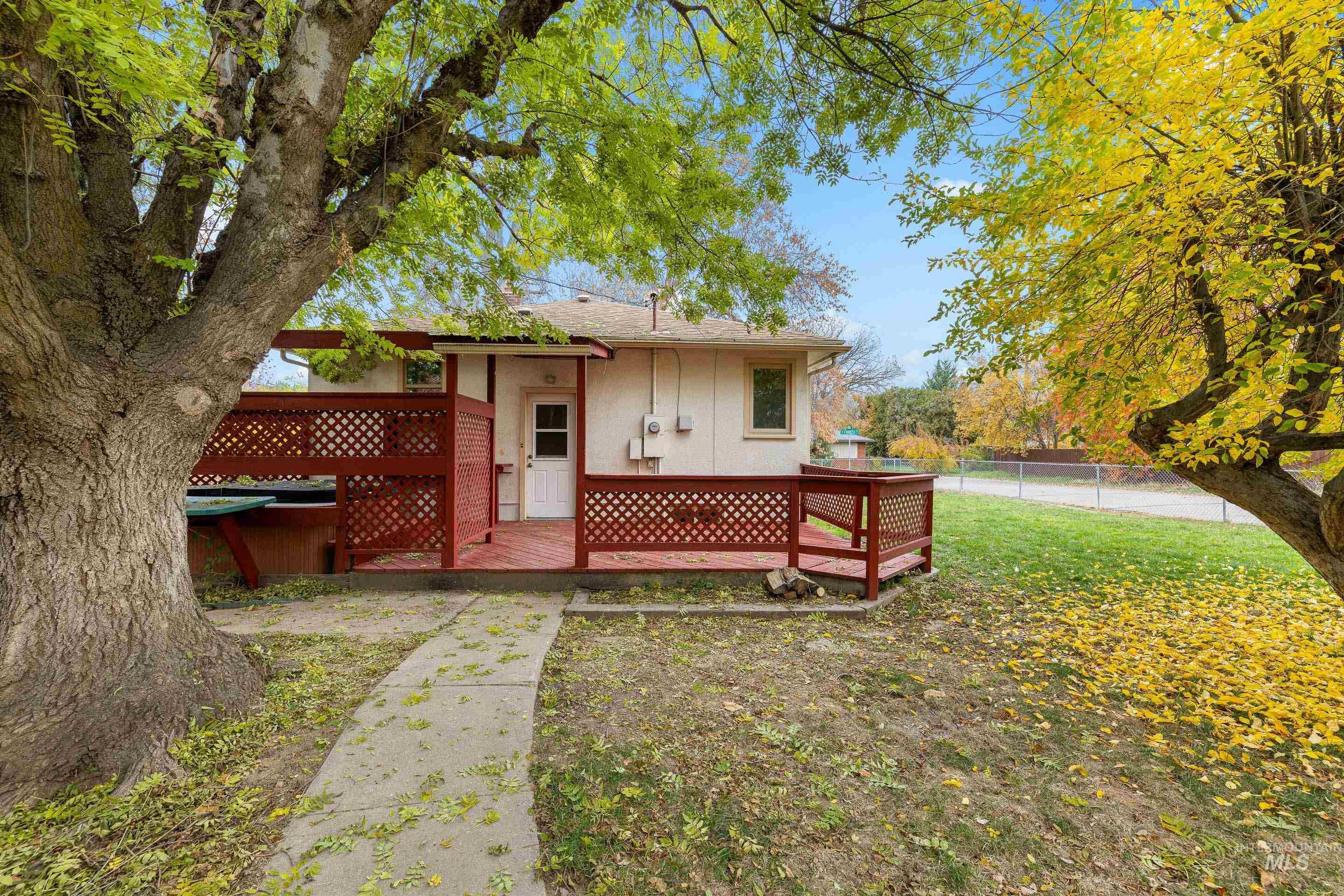 Rear view of property featuring a deck and a shingled roof