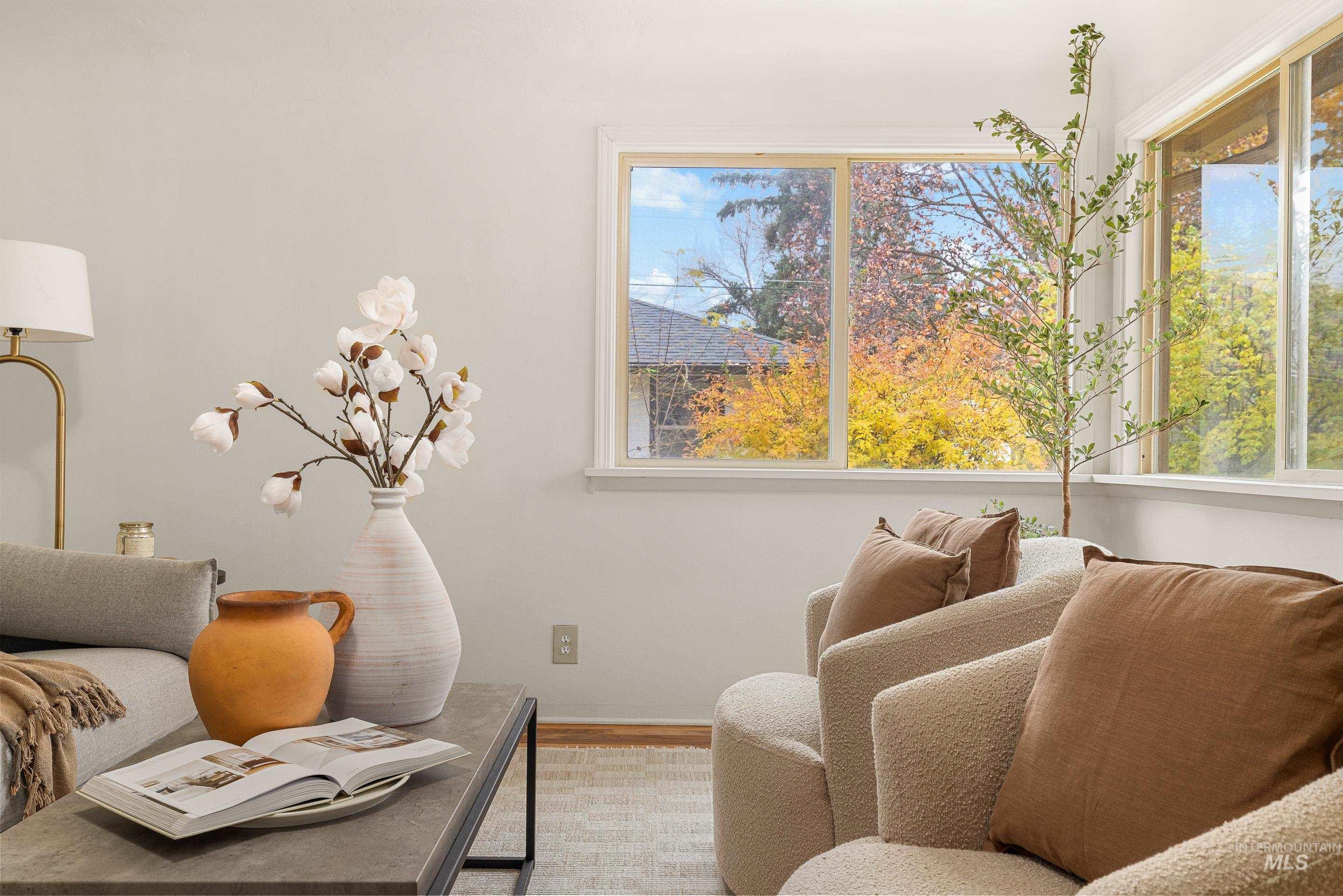 Living area with healthy amount of natural light and wood finished floors