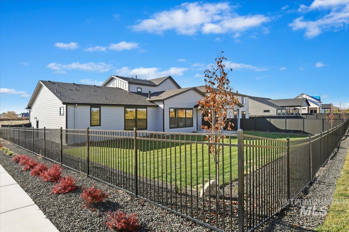 View of front facade with a fenced backyard