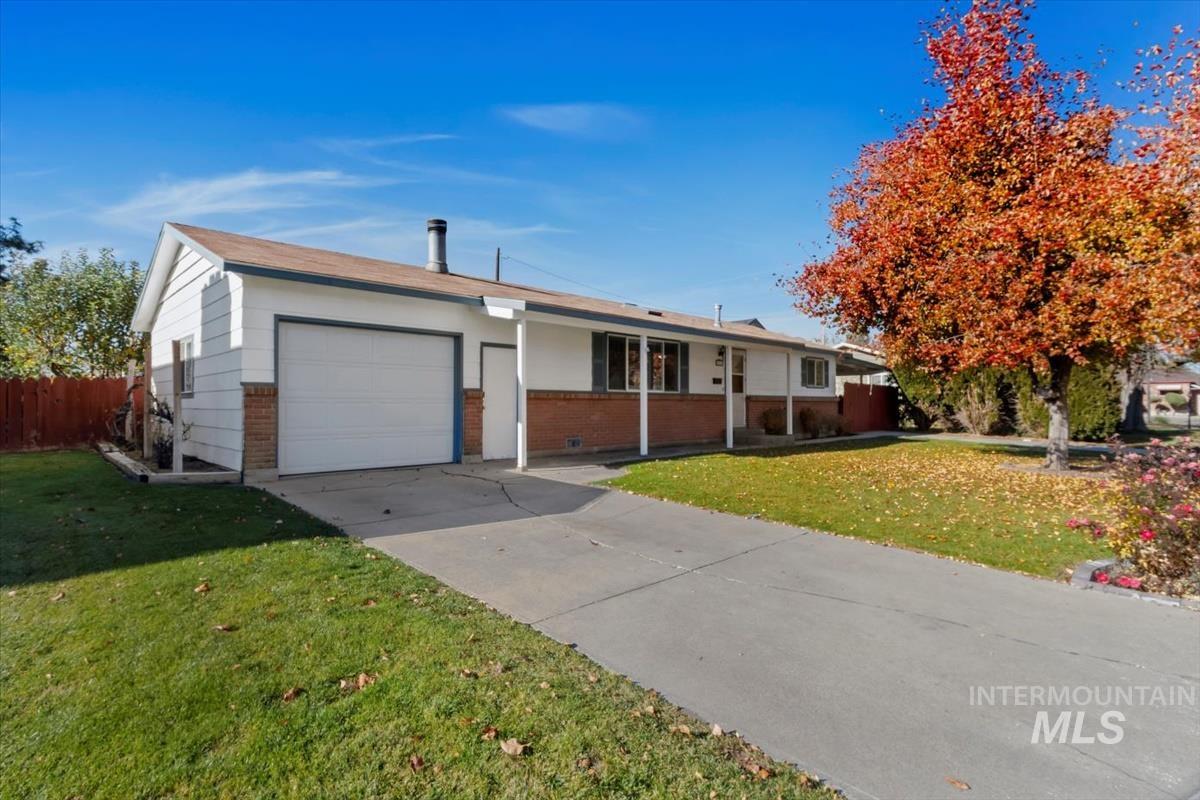 Ranch-style house with brick siding, a garage, and driveway