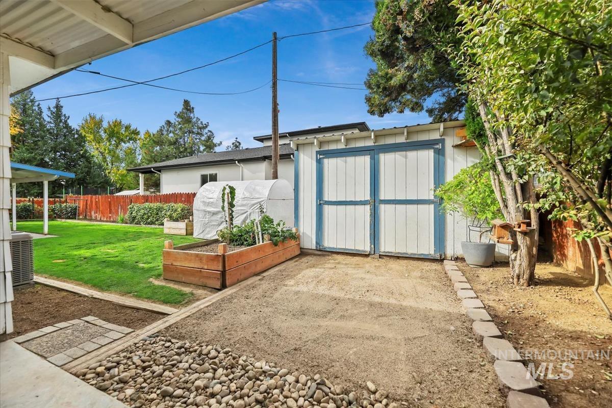 View of shed with a vegetable garden