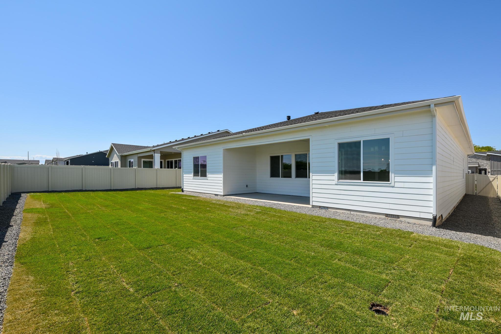 Back of house featuring a fenced backyard and a patio