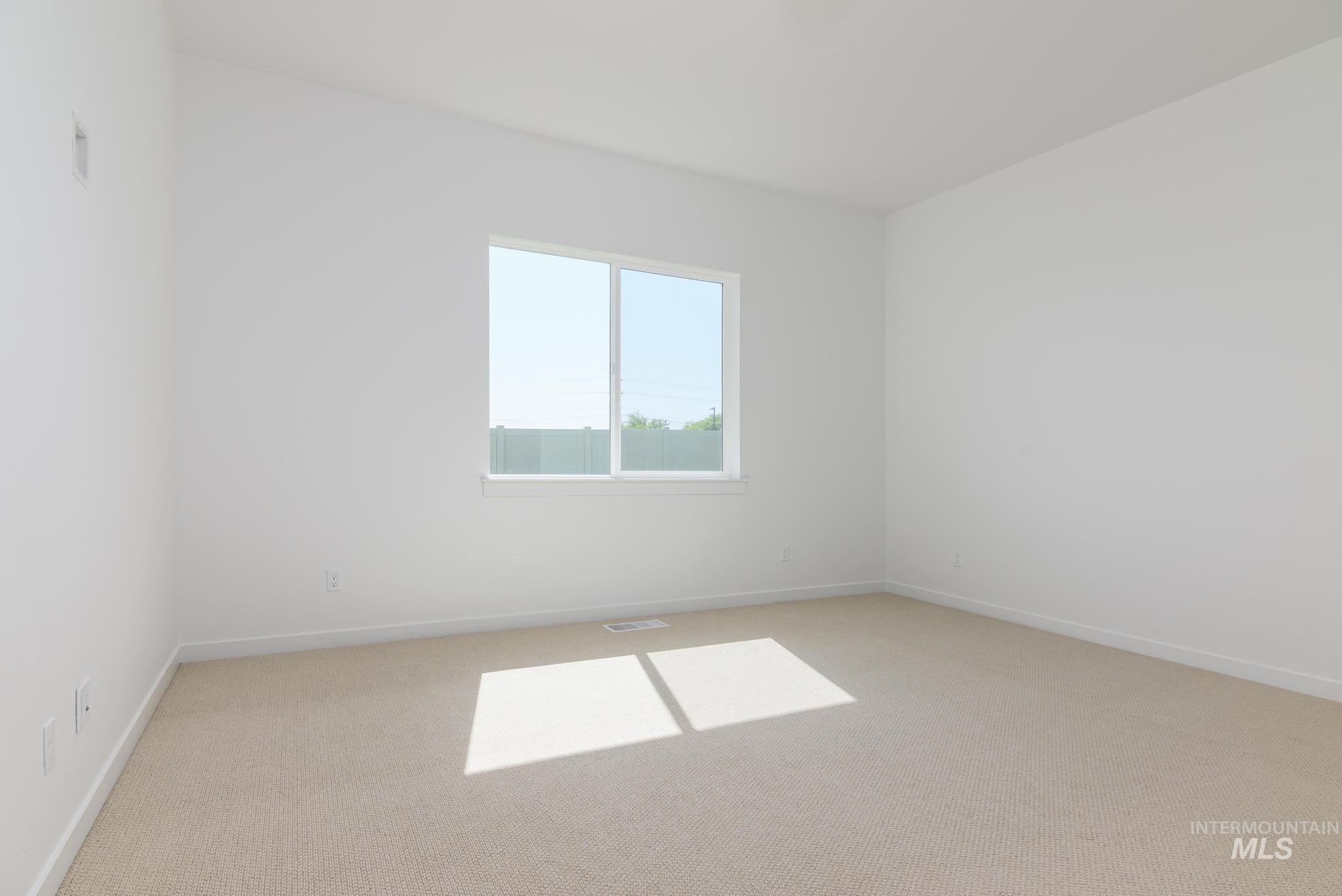 Unfurnished room with light carpet and baseboards
