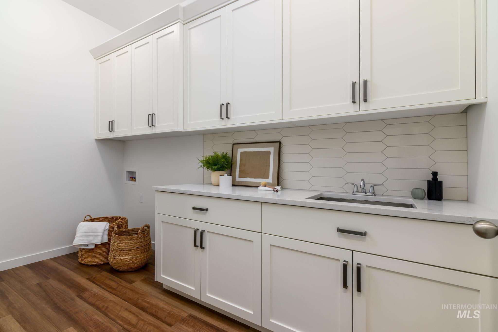 Laundry area featuring cabinet space, dark wood-style flooring, and hookup for a washing machine