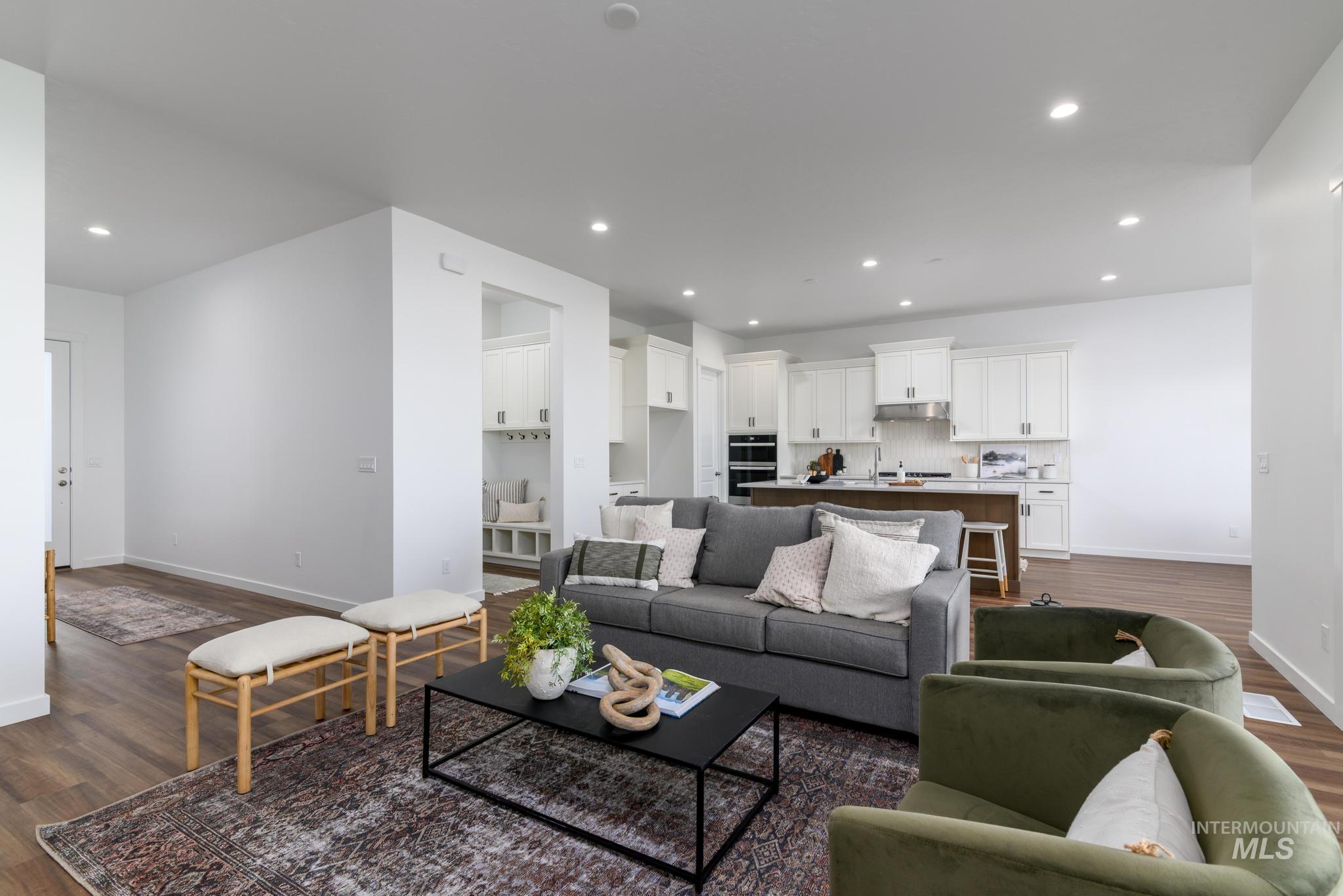 Living room featuring dark wood finished floors and recessed lighting