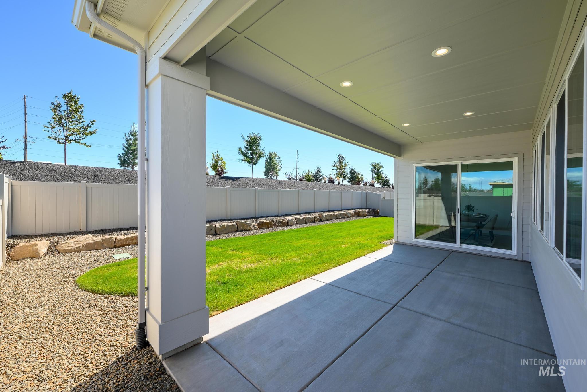 Fenced backyard with a patio area