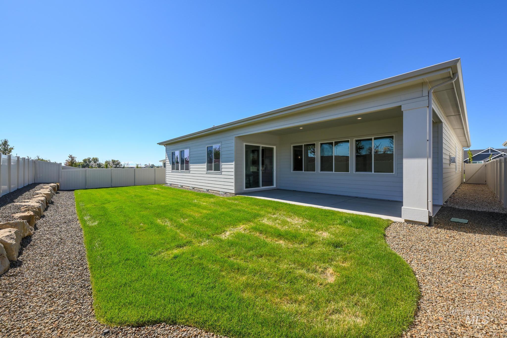 Back of house featuring a fenced backyard and a patio