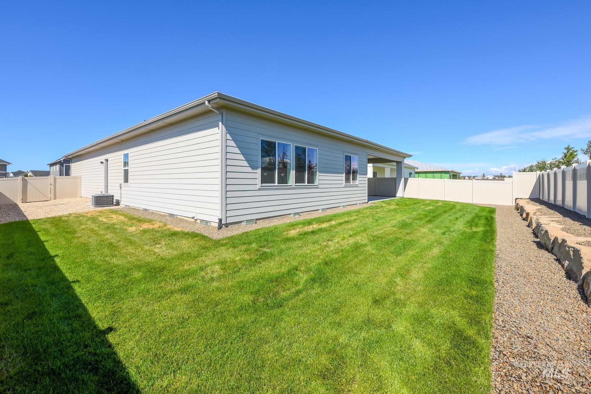Rear view of property with a fenced backyard