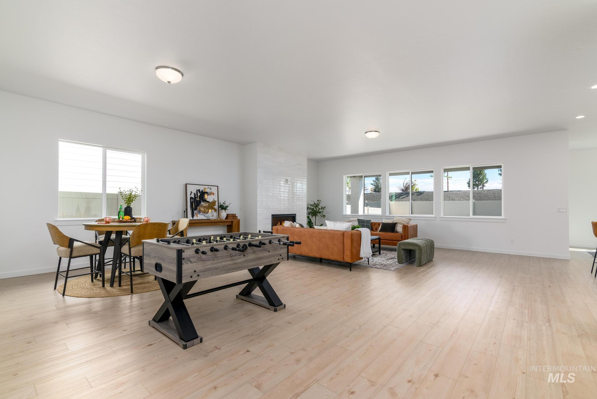 Game room featuring baseboards and light wood finished floors