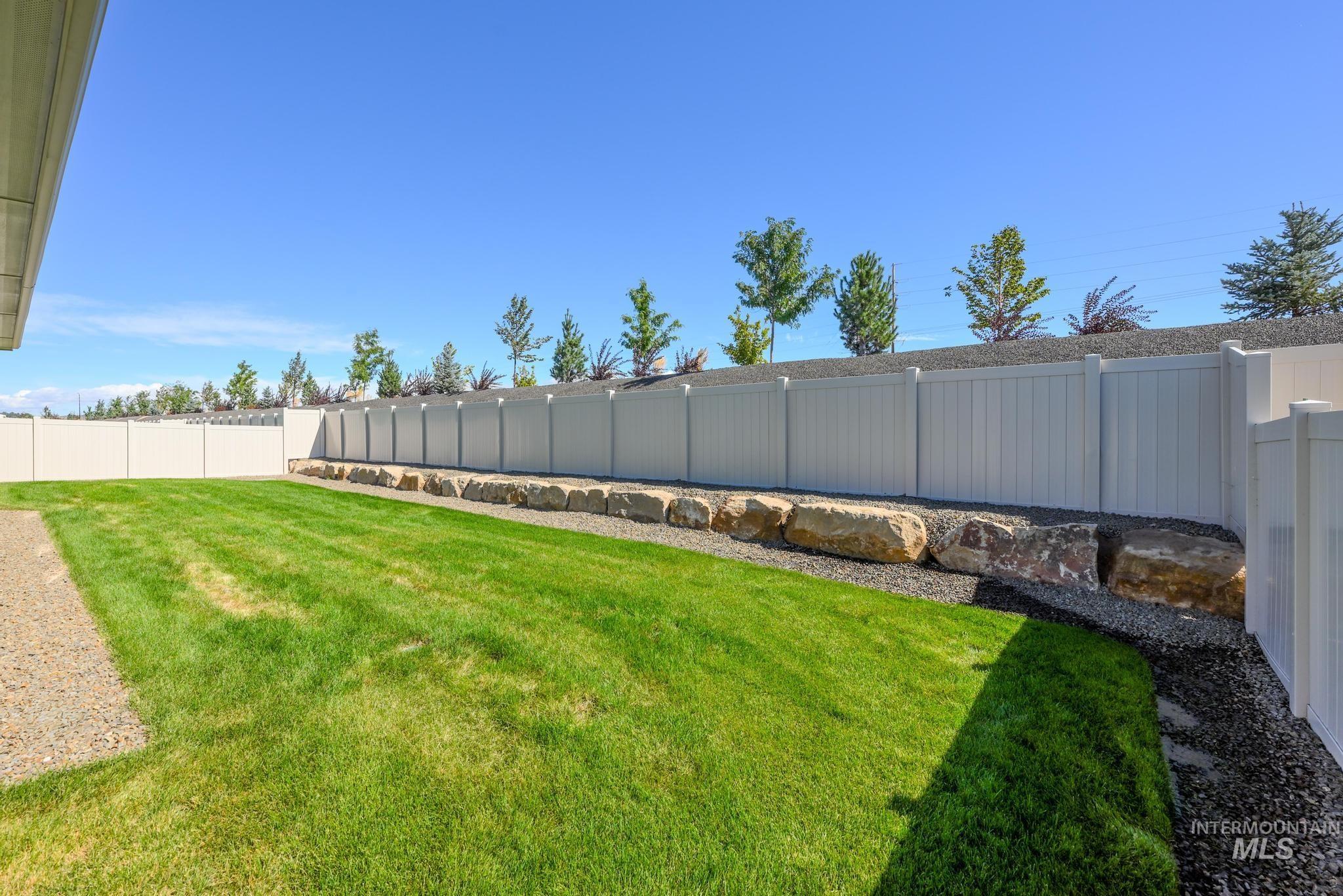 View of fenced backyard