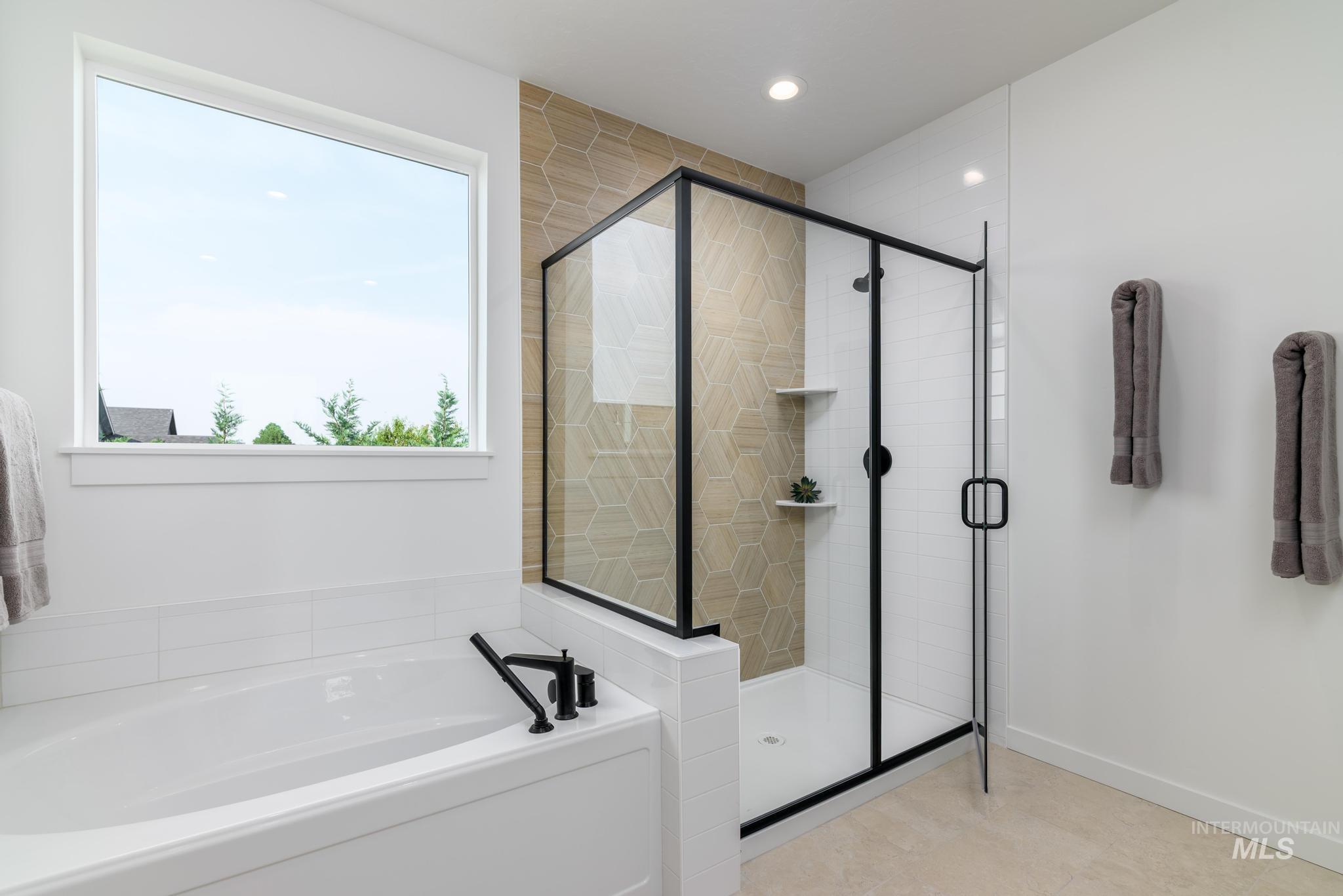 Full bathroom featuring a stall shower, a garden tub, and recessed lighting