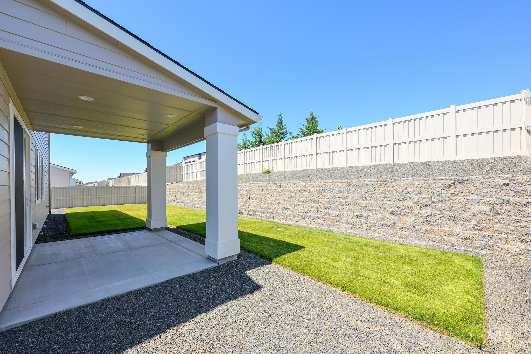 Fenced backyard featuring a patio