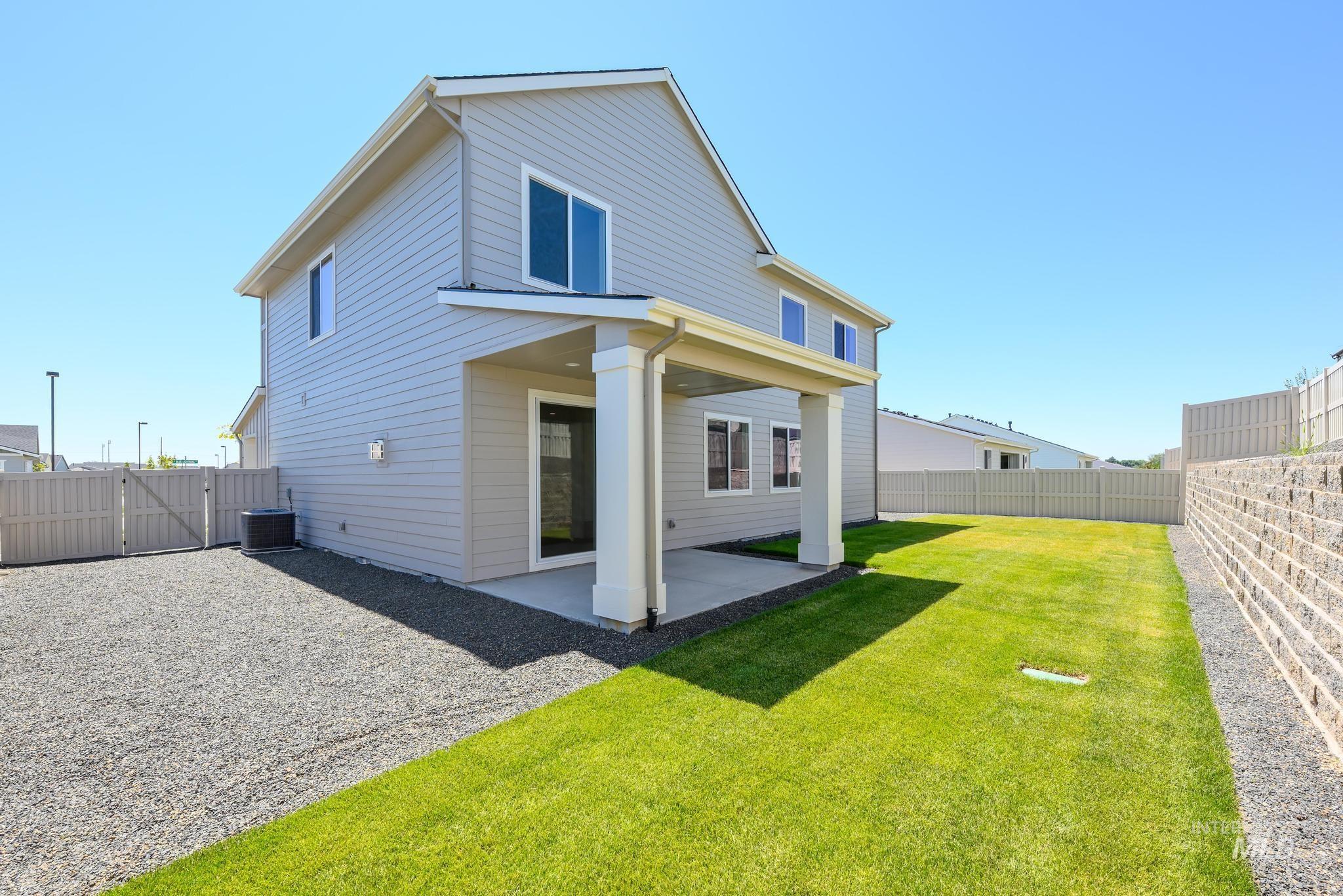 Back of house featuring a gate, a patio, and a fenced backyard