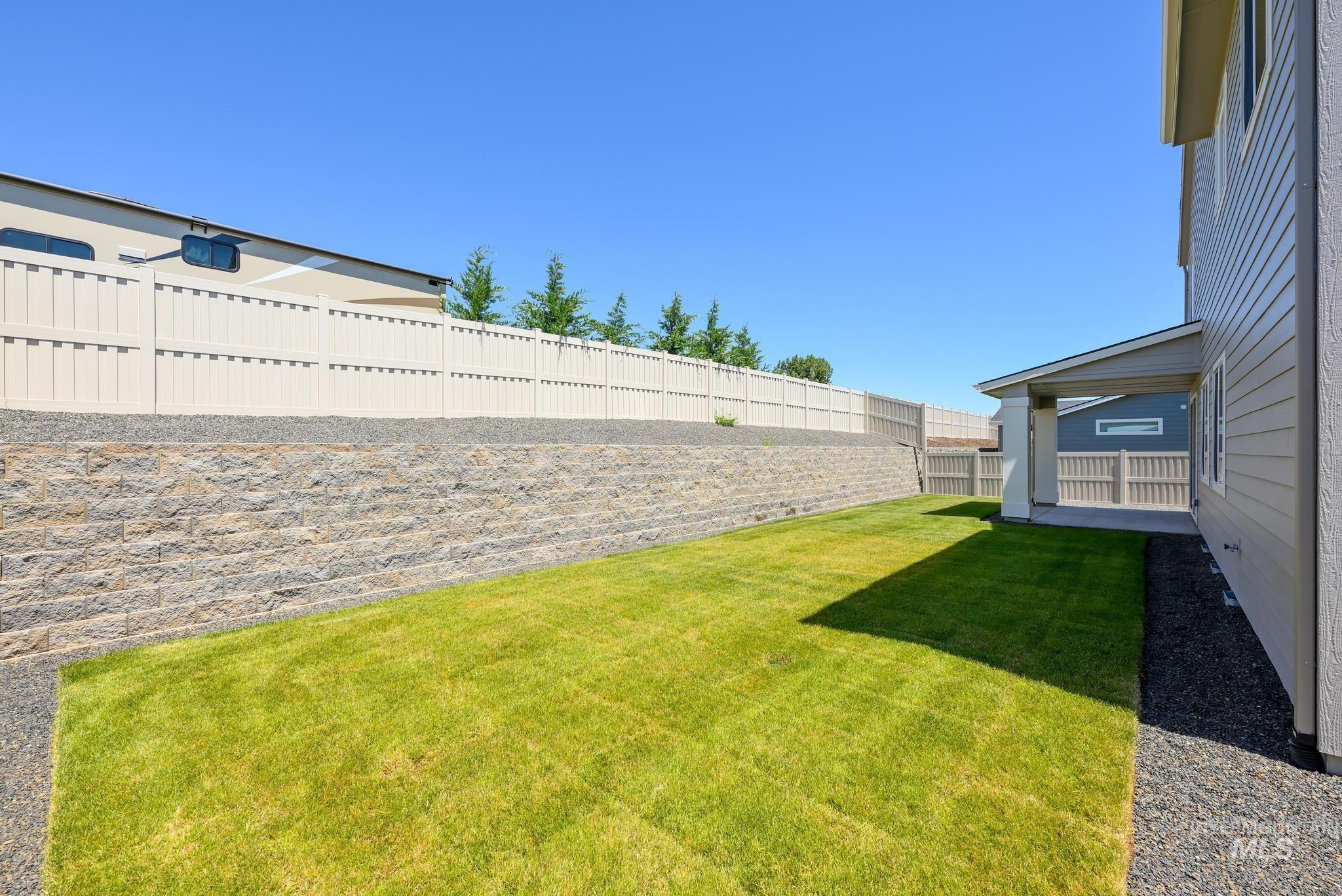 View of fenced backyard
