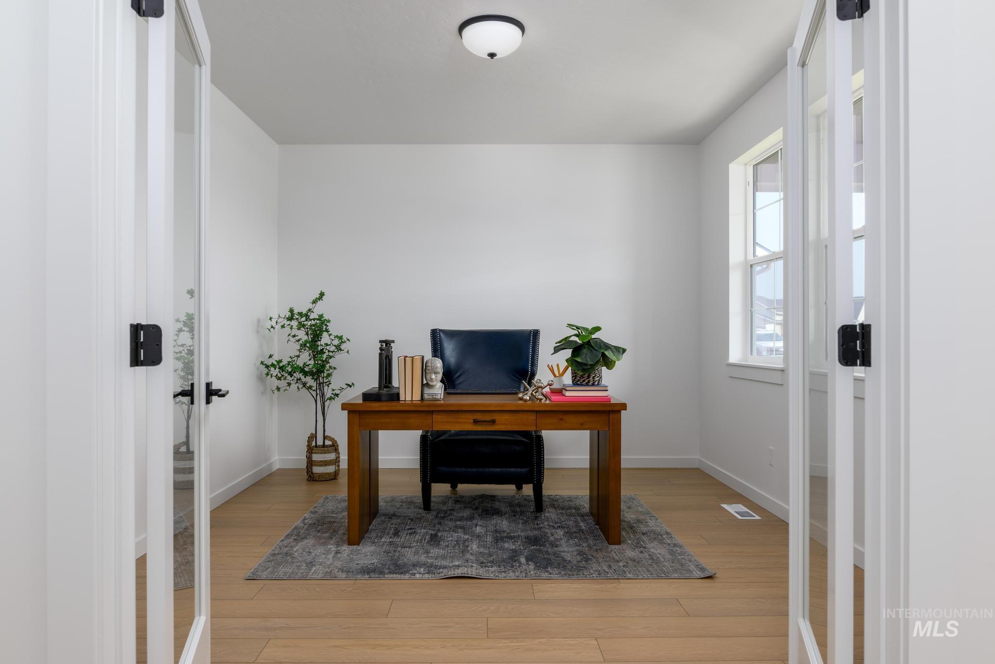 Office area featuring light wood-type flooring and baseboards