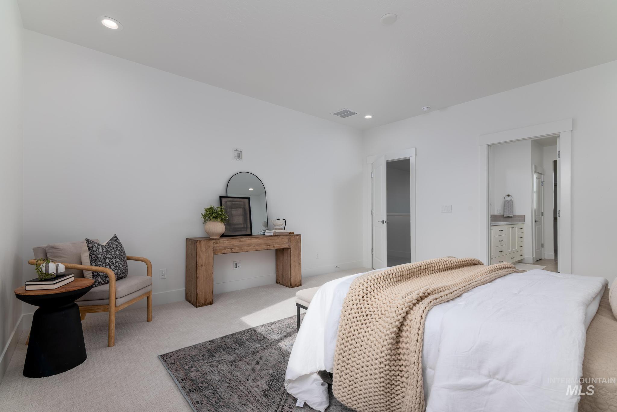 Bedroom with carpet flooring, recessed lighting, and connected bathroom