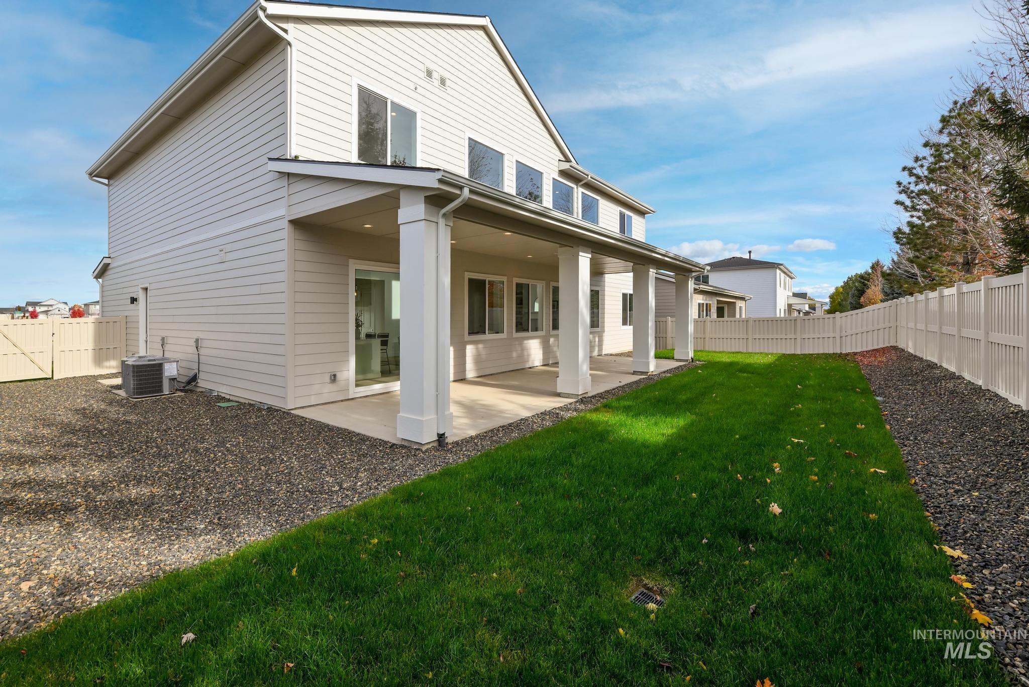 Rear view of property featuring a fenced backyard and a patio