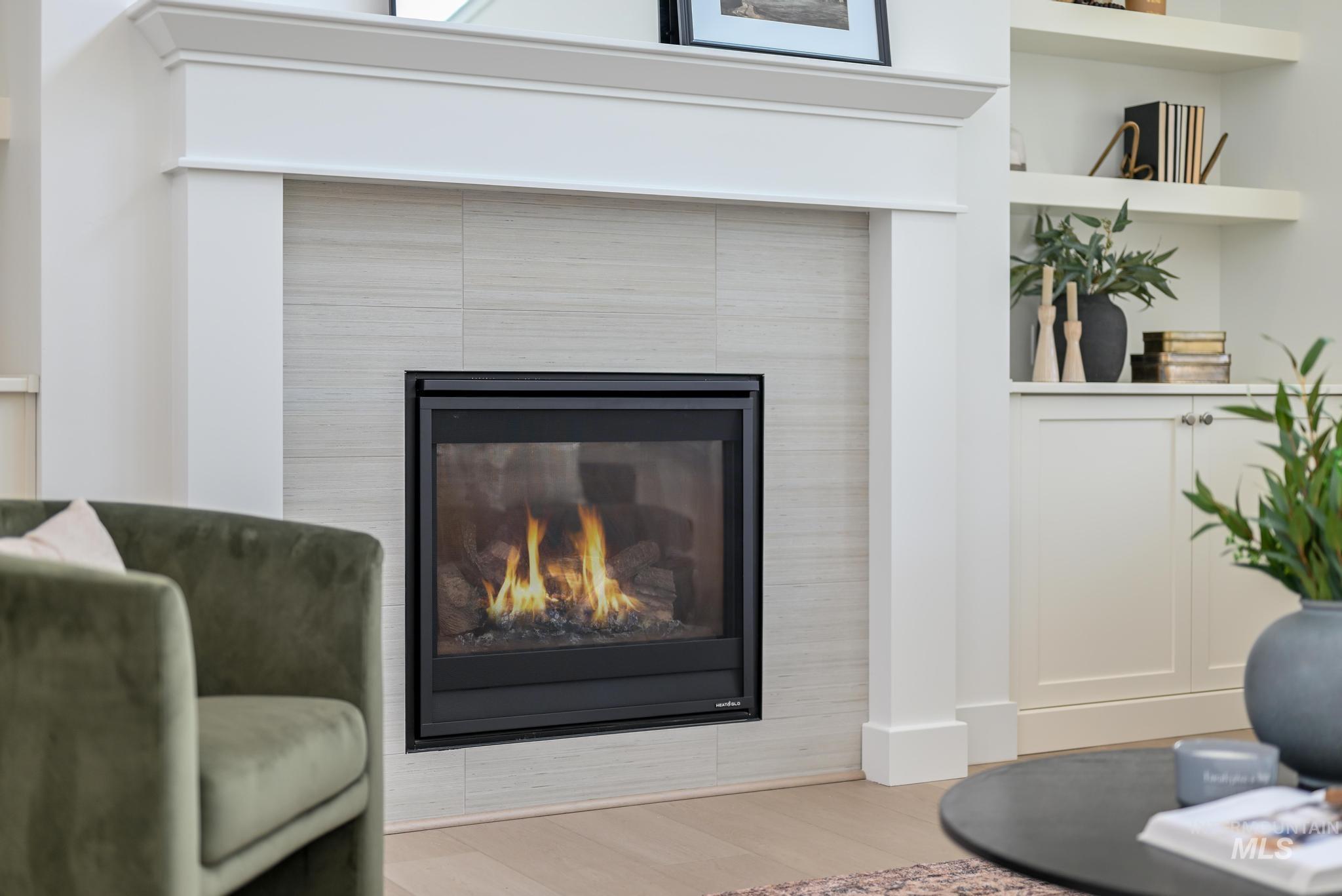 Sitting room featuring wood finished floors and a tiled fireplace