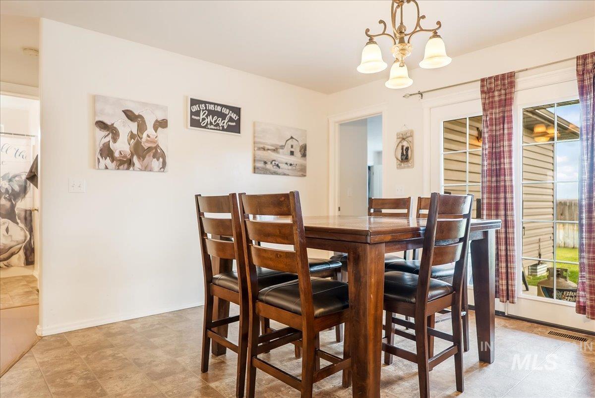 Dining space featuring a chandelier and baseboards