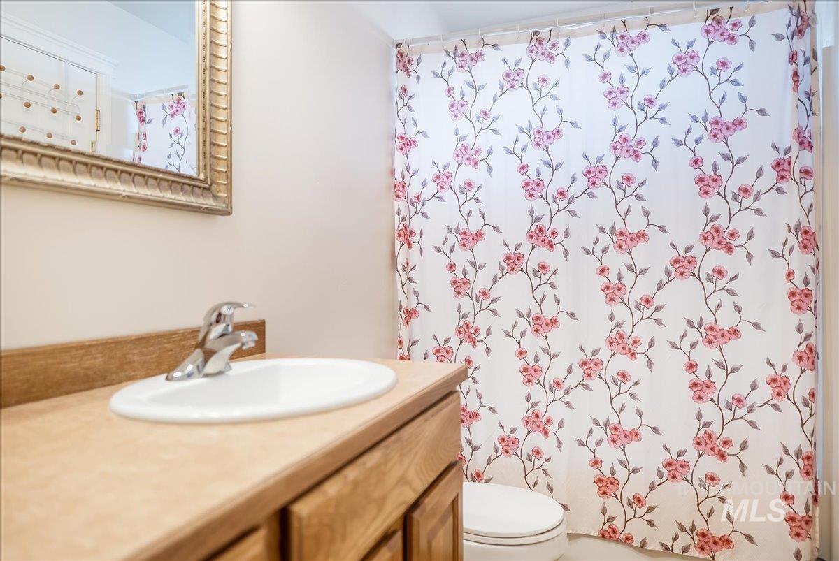 Full bathroom featuring vanity and toilet
