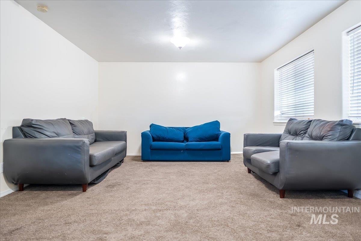 Living room with carpet floors and baseboards