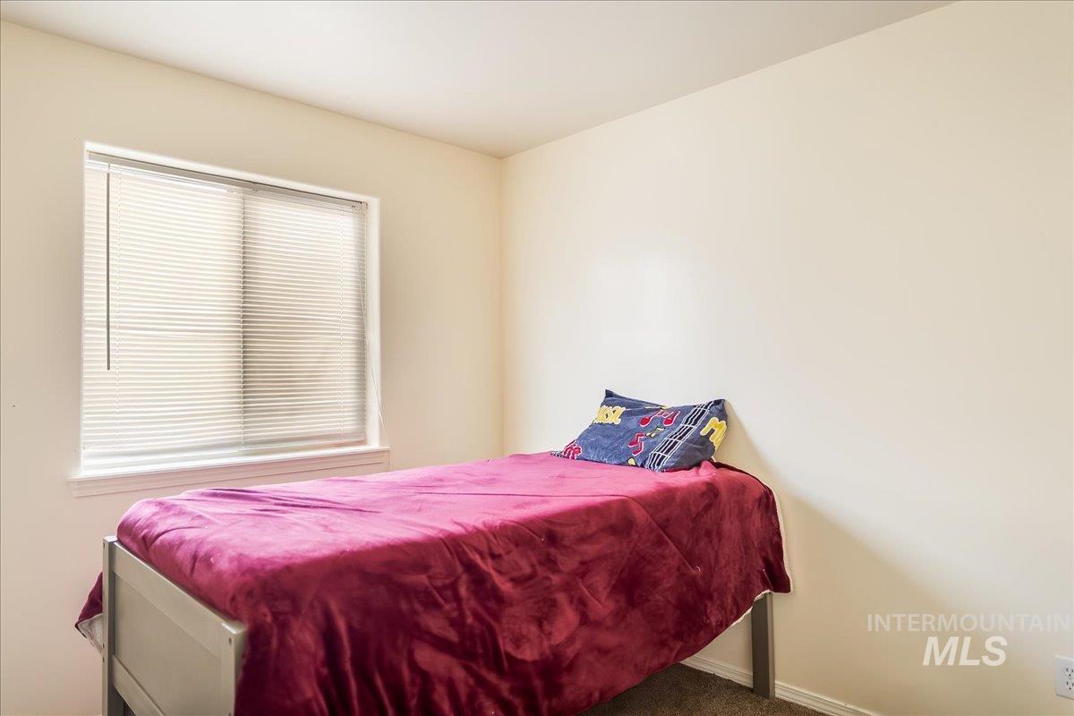 Carpeted bedroom with baseboards