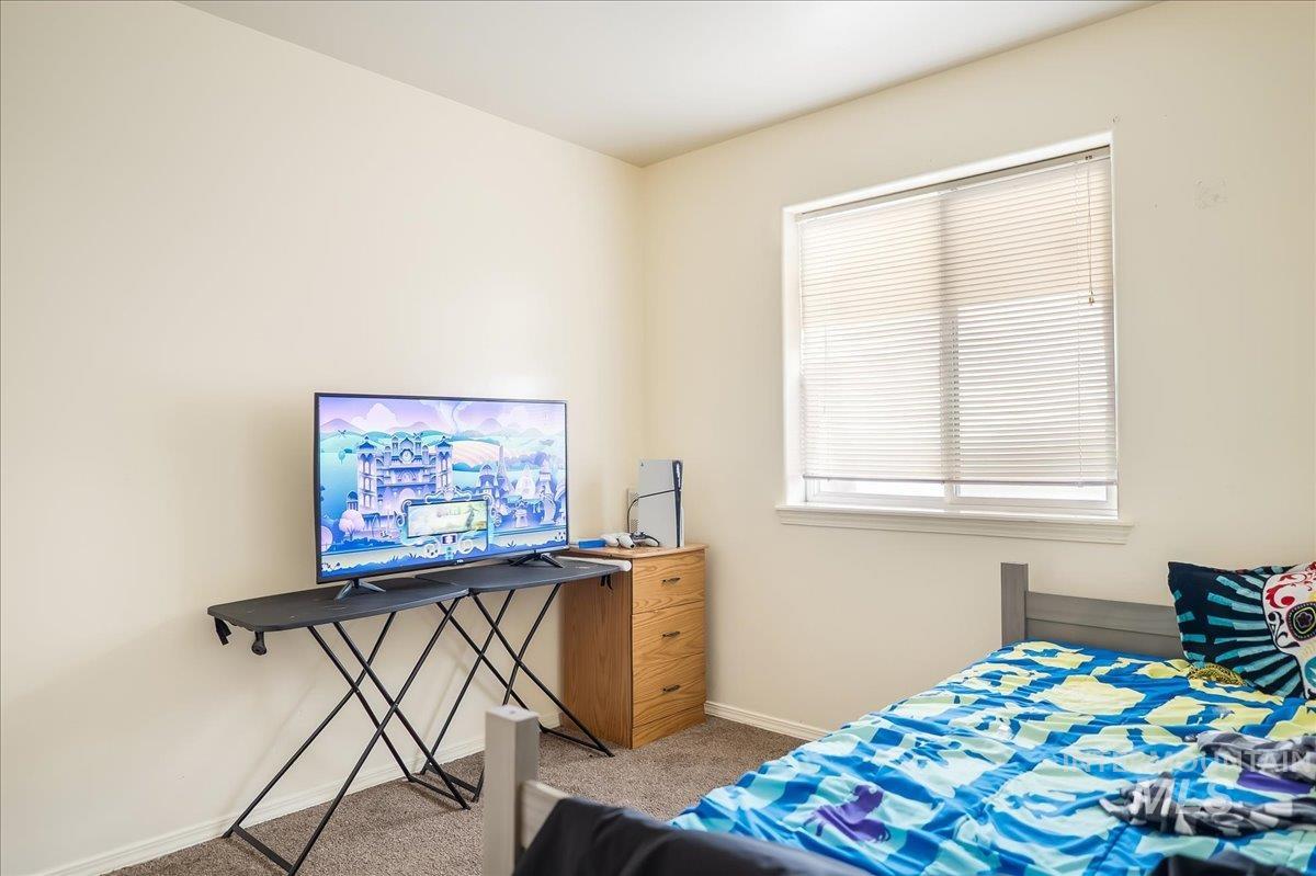 Bedroom with carpet flooring and baseboards