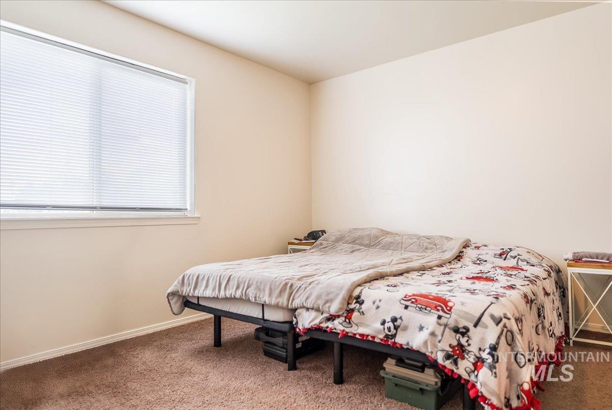 Carpeted bedroom with baseboards
