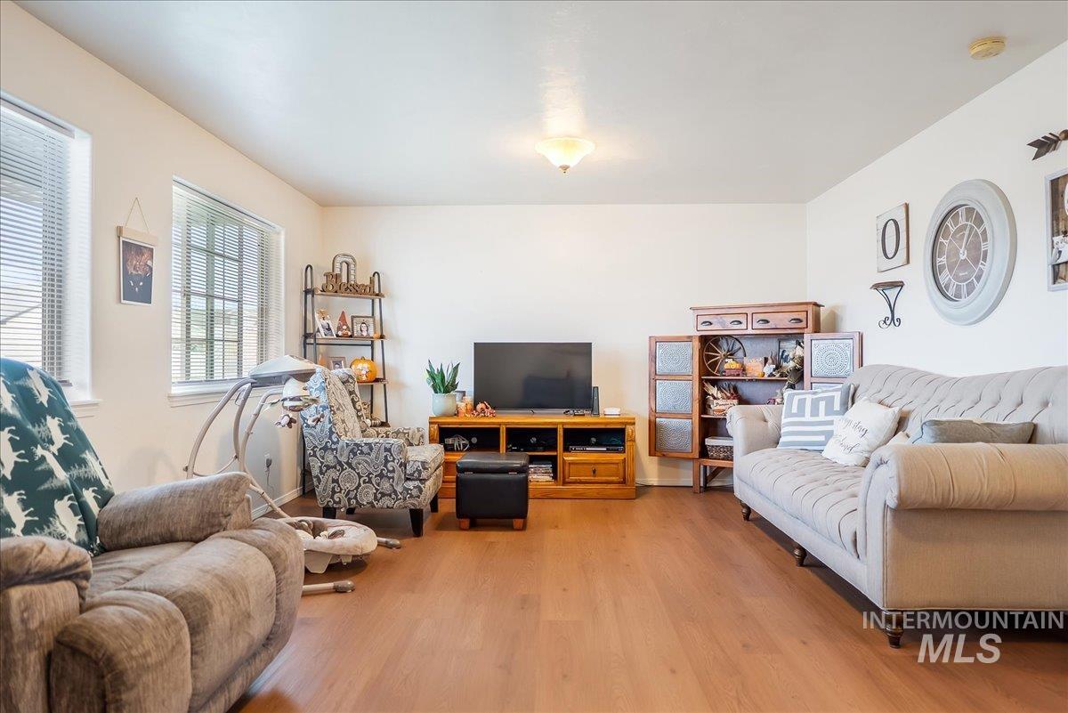 Living room with light wood-style floors and baseboards