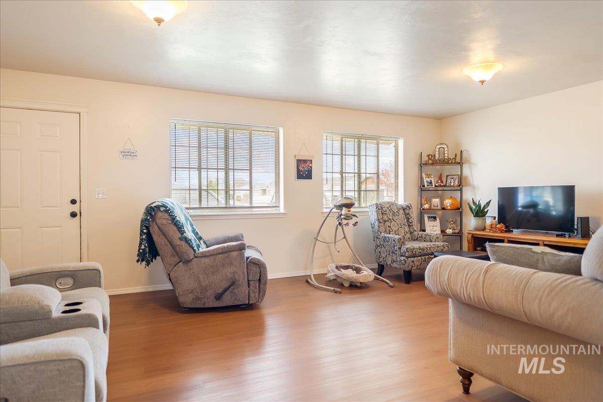 Living area with wood finished floors and baseboards