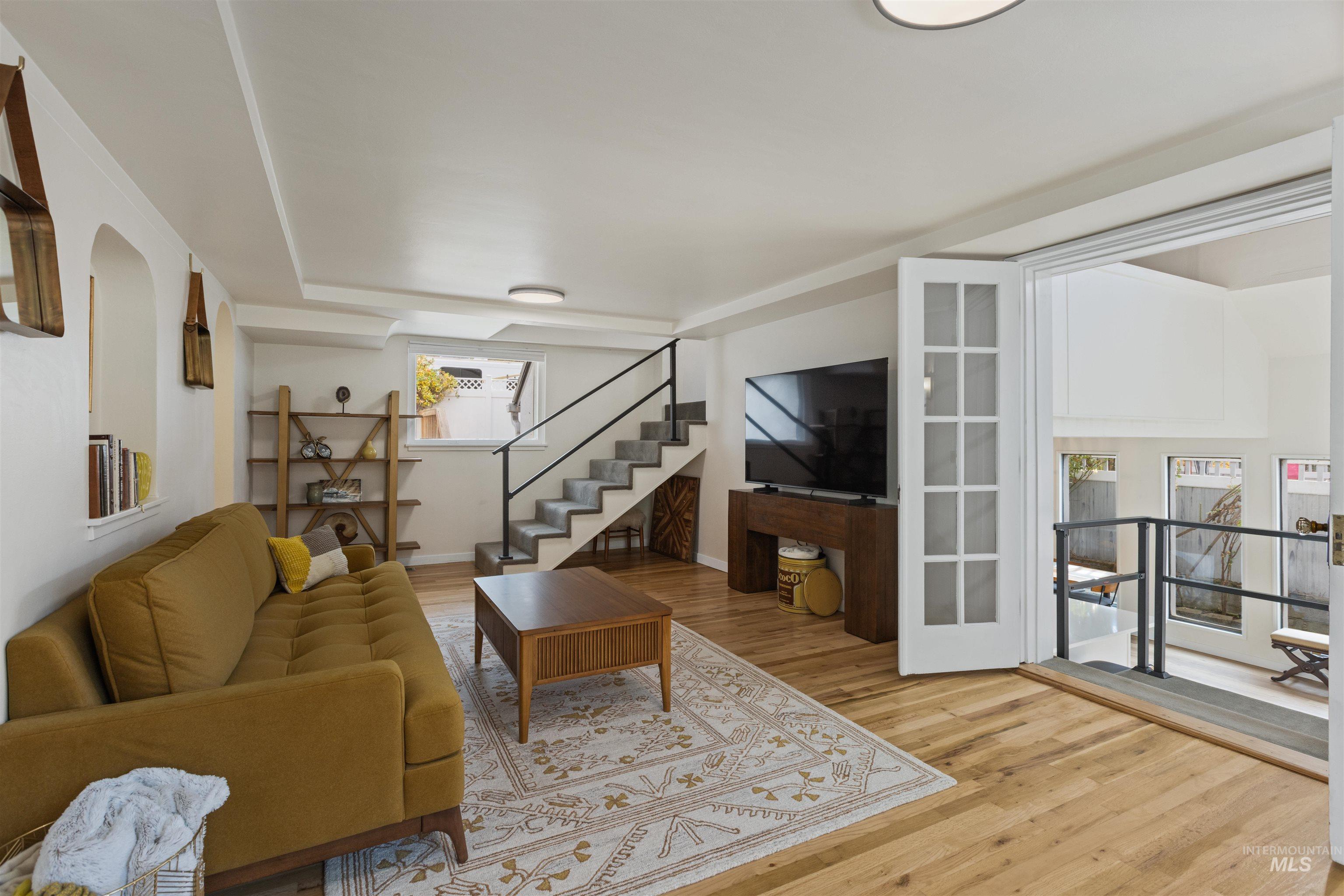 Living area with stairway and light wood-style flooring