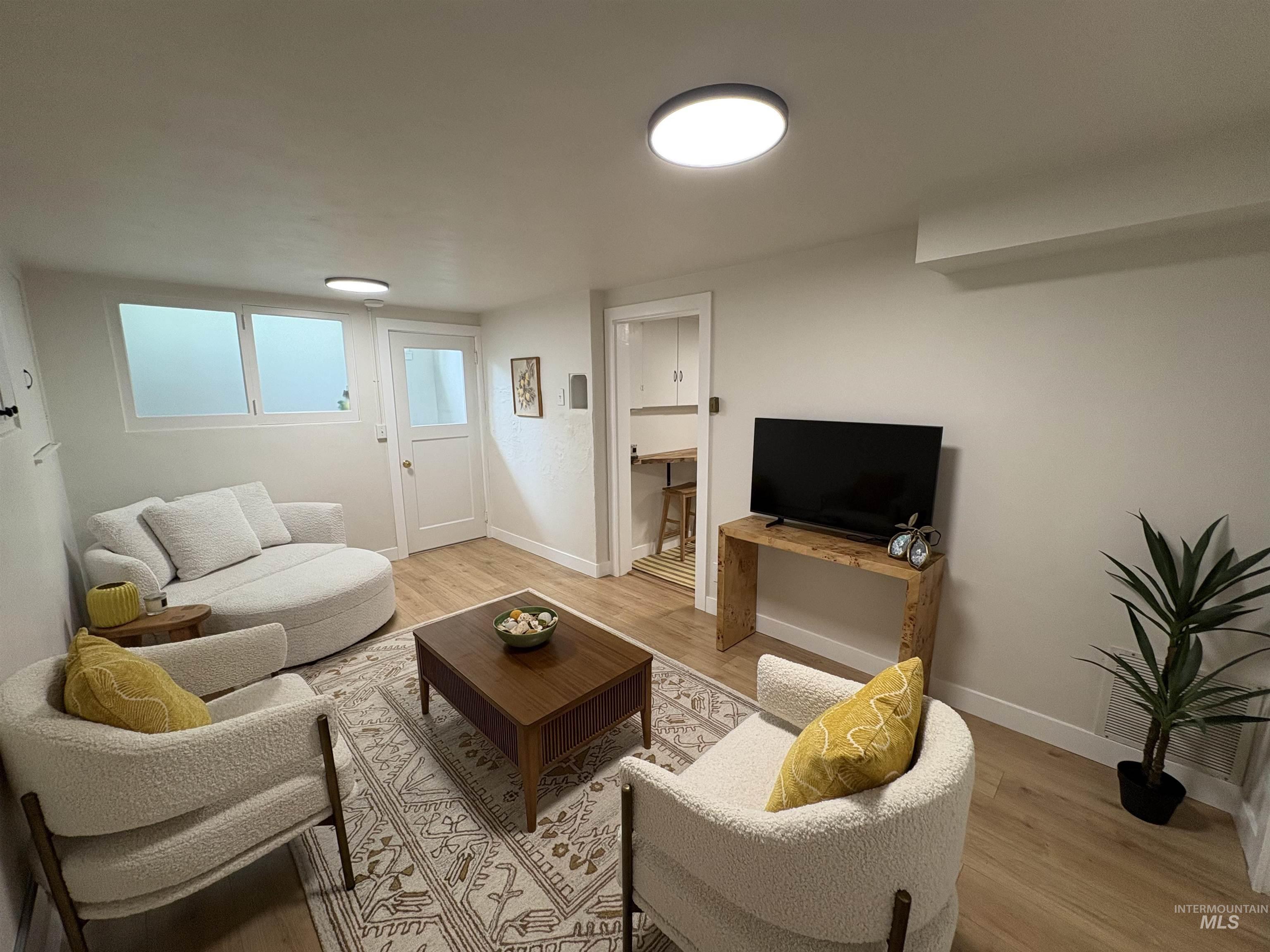 Living area with wood finished floors and baseboards