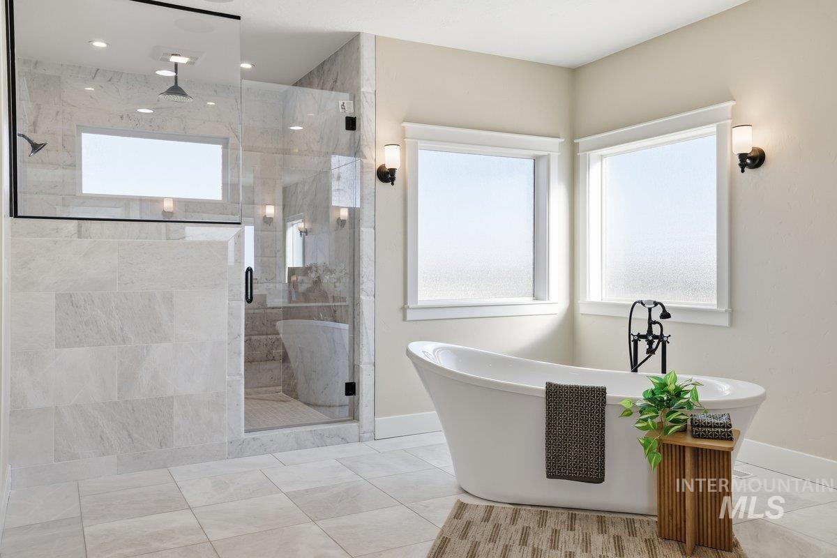 Full bath with marble walk-in shower, a freestanding soaker tub and bidet