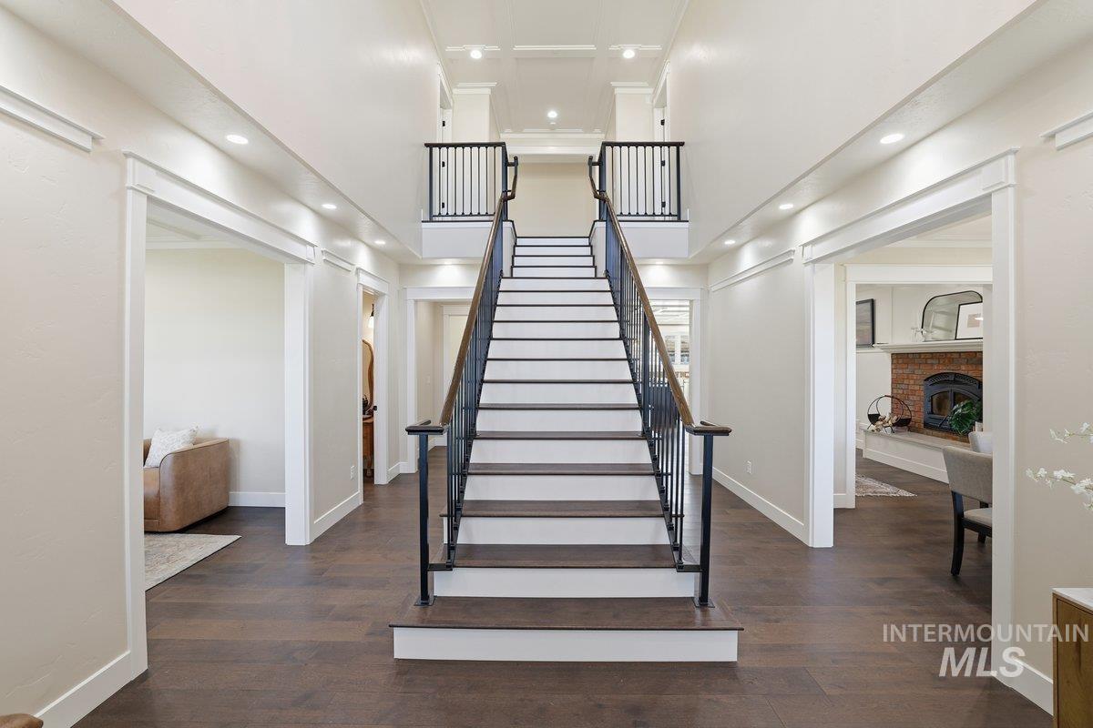 Staircase featuring wood finished floors, recessed lighting