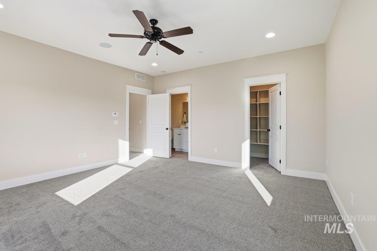 Jr Suite  featuring carpet floors, a walk in closet, recessed lighting, a ceiling fan, connected bathroom and private balcony.