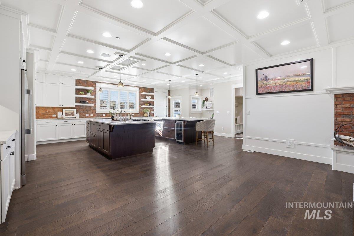 Kitchen with open shelves, decorative light fixtures, a kitchen bar, dark wood finished floors, and dark brown cabinetry