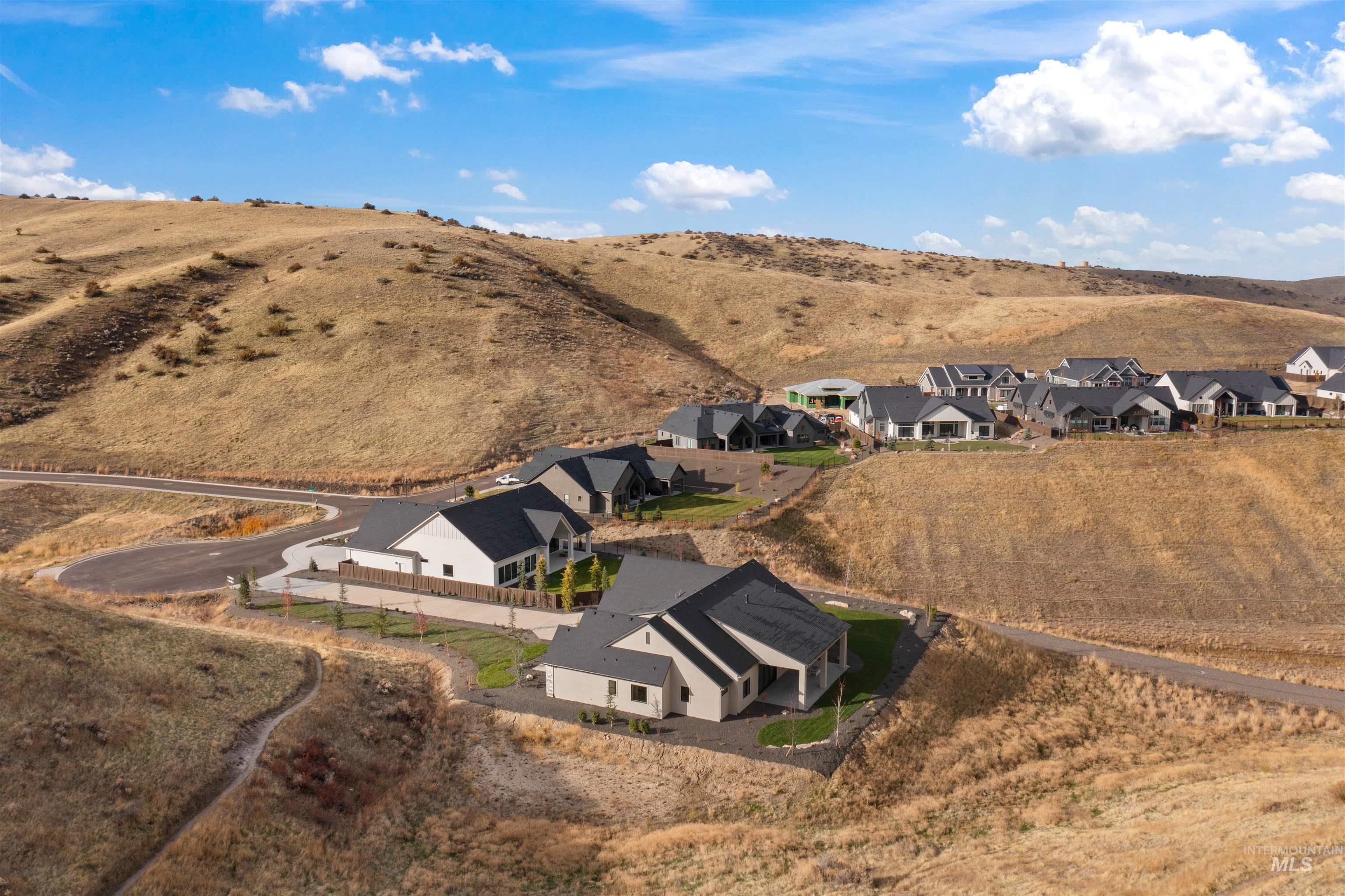 Aerial view of property's location featuring a mountainous background