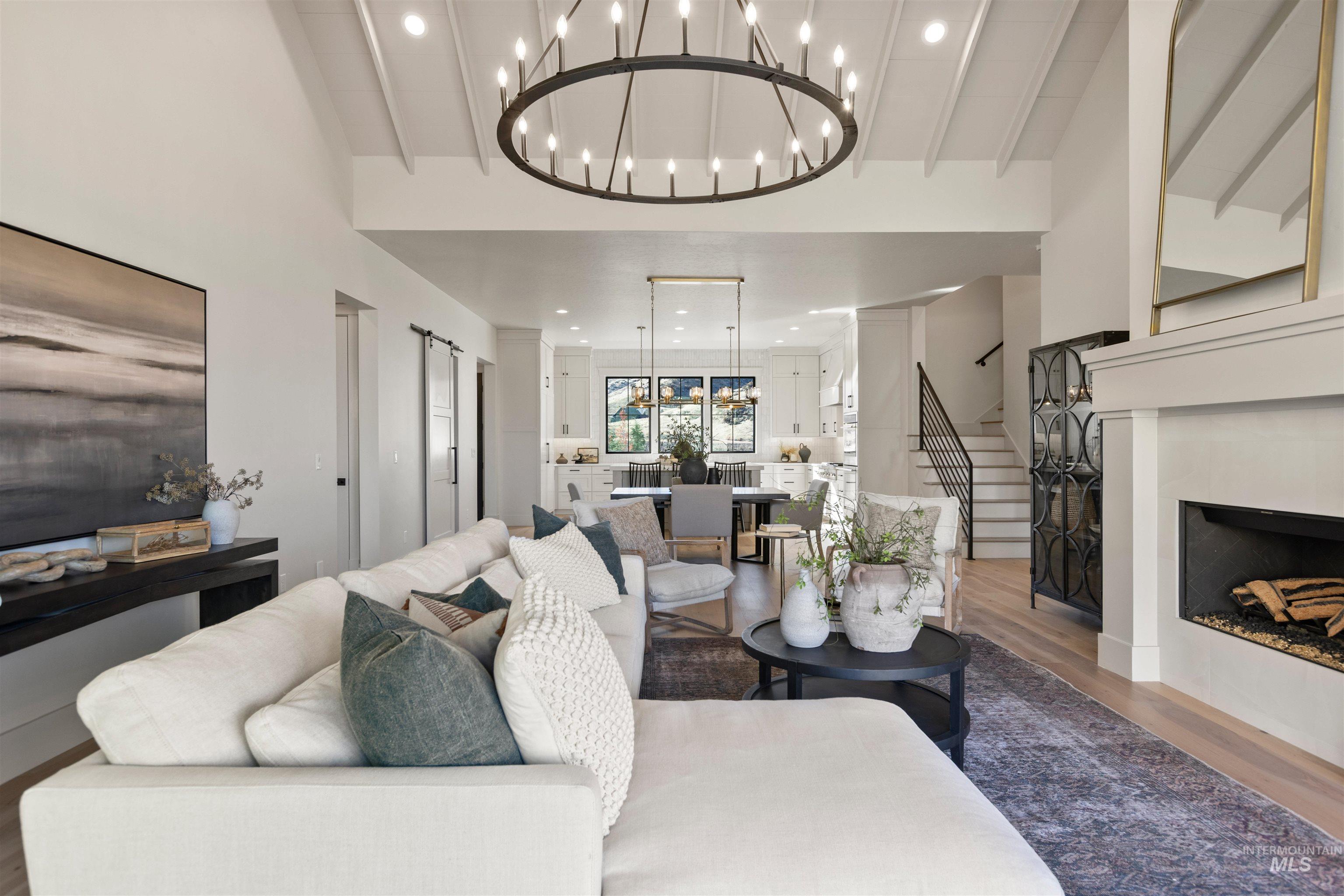 Living area featuring wood finished floors, a fireplace, stairway, and recessed lighting