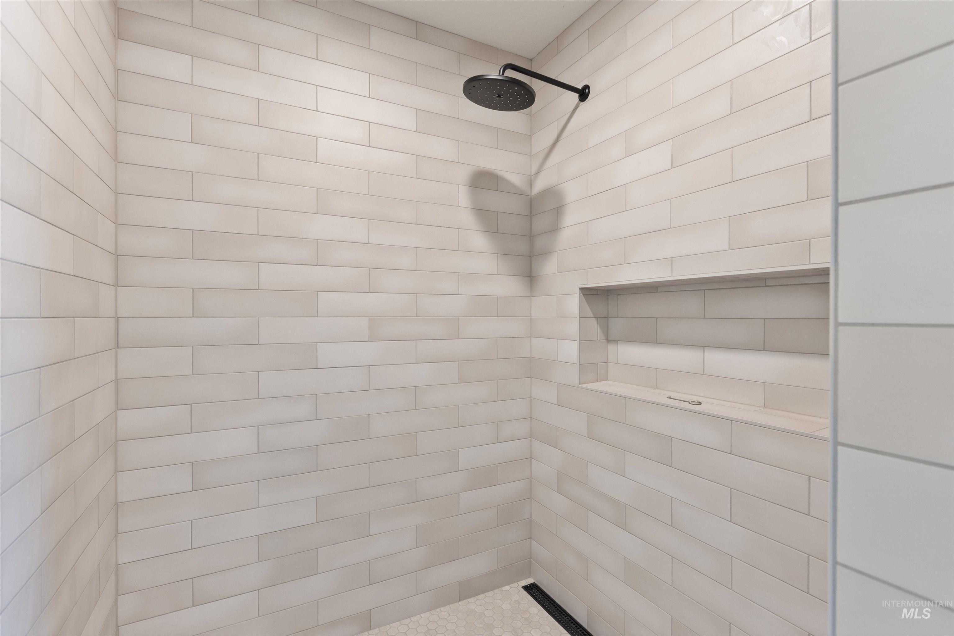 Full bath featuring tiled shower