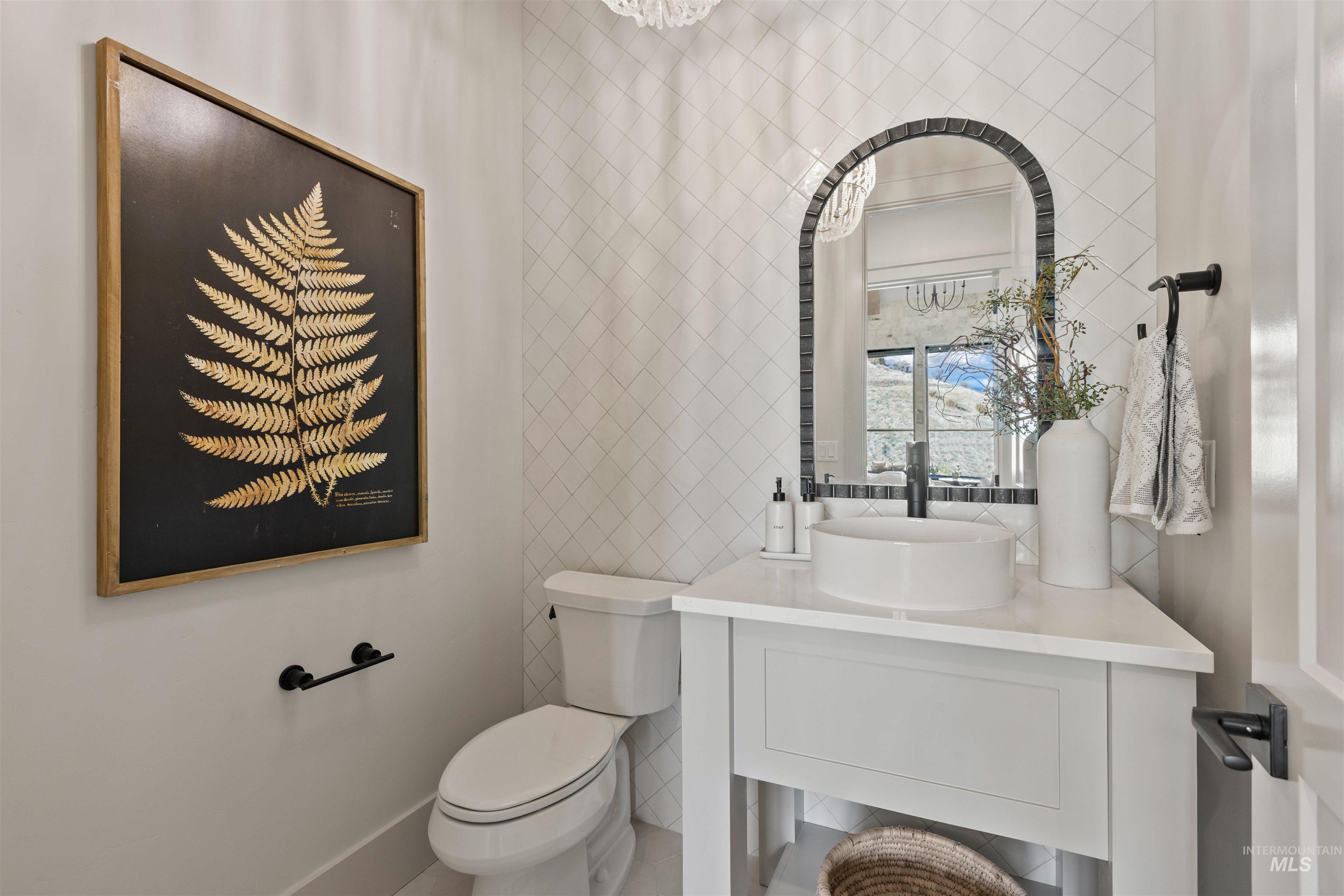 Bathroom featuring tile walls and vanity