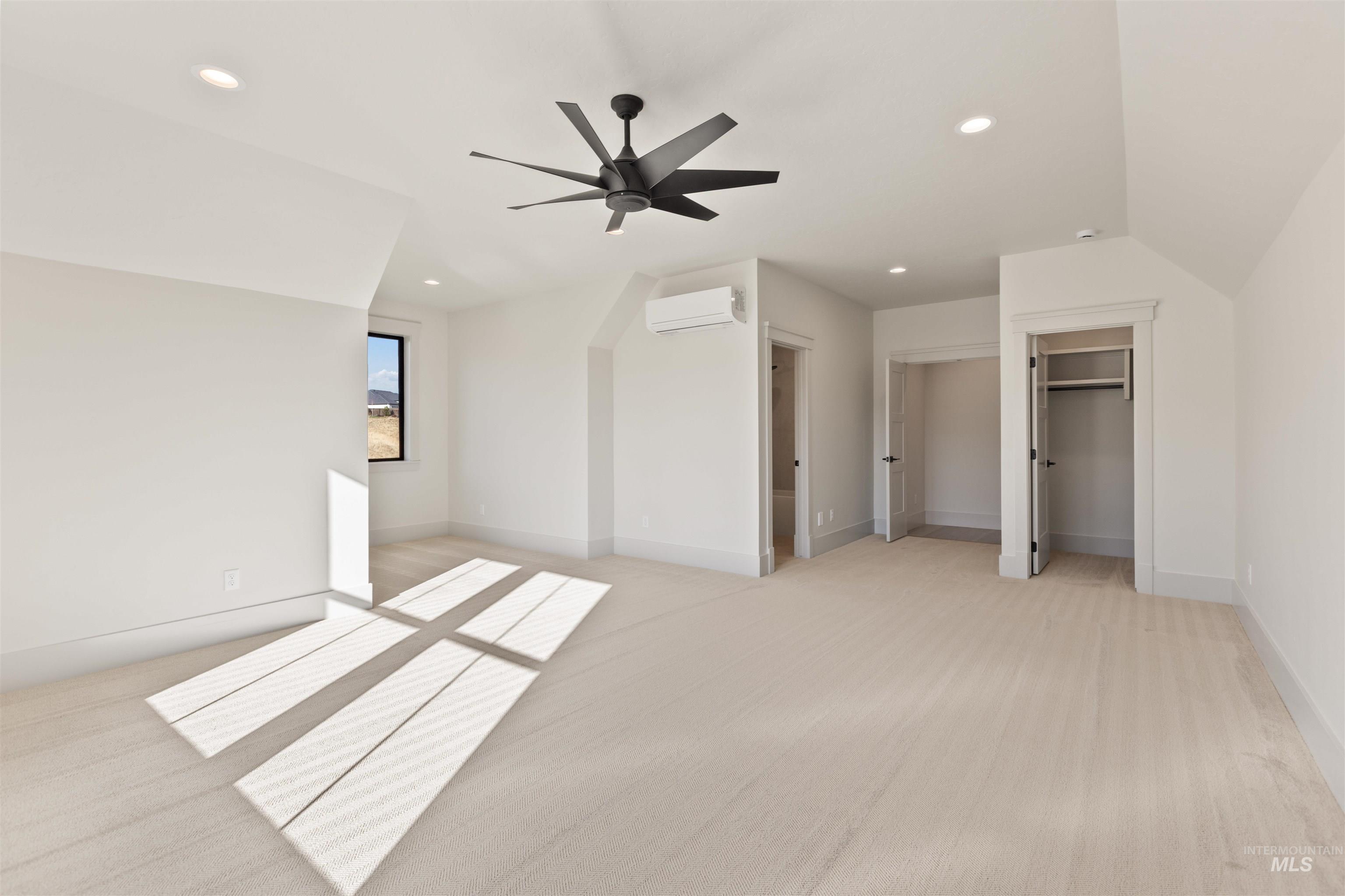 Unfurnished bedroom with recessed lighting, ceiling fan, light carpet, and a wall mounted air conditioner