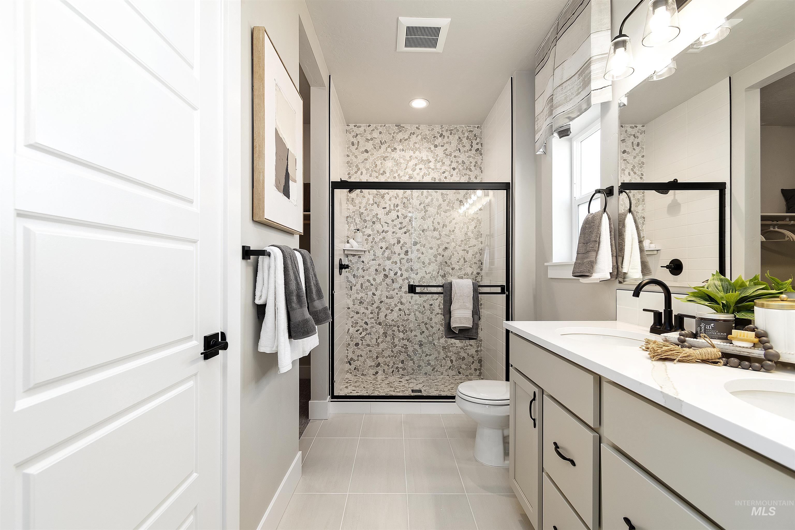 Bathroom with light tile patterned flooring, double vanity, a stall shower, and recessed lighting