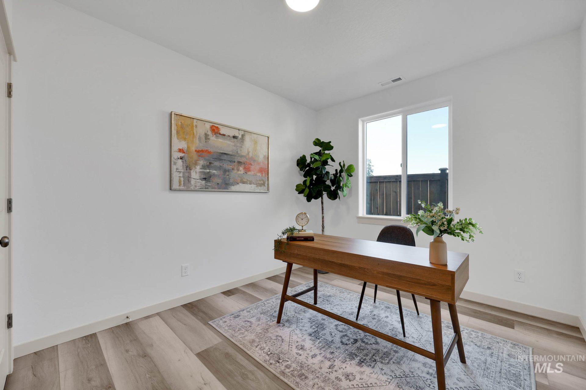 Home office featuring baseboards and light wood-style flooring