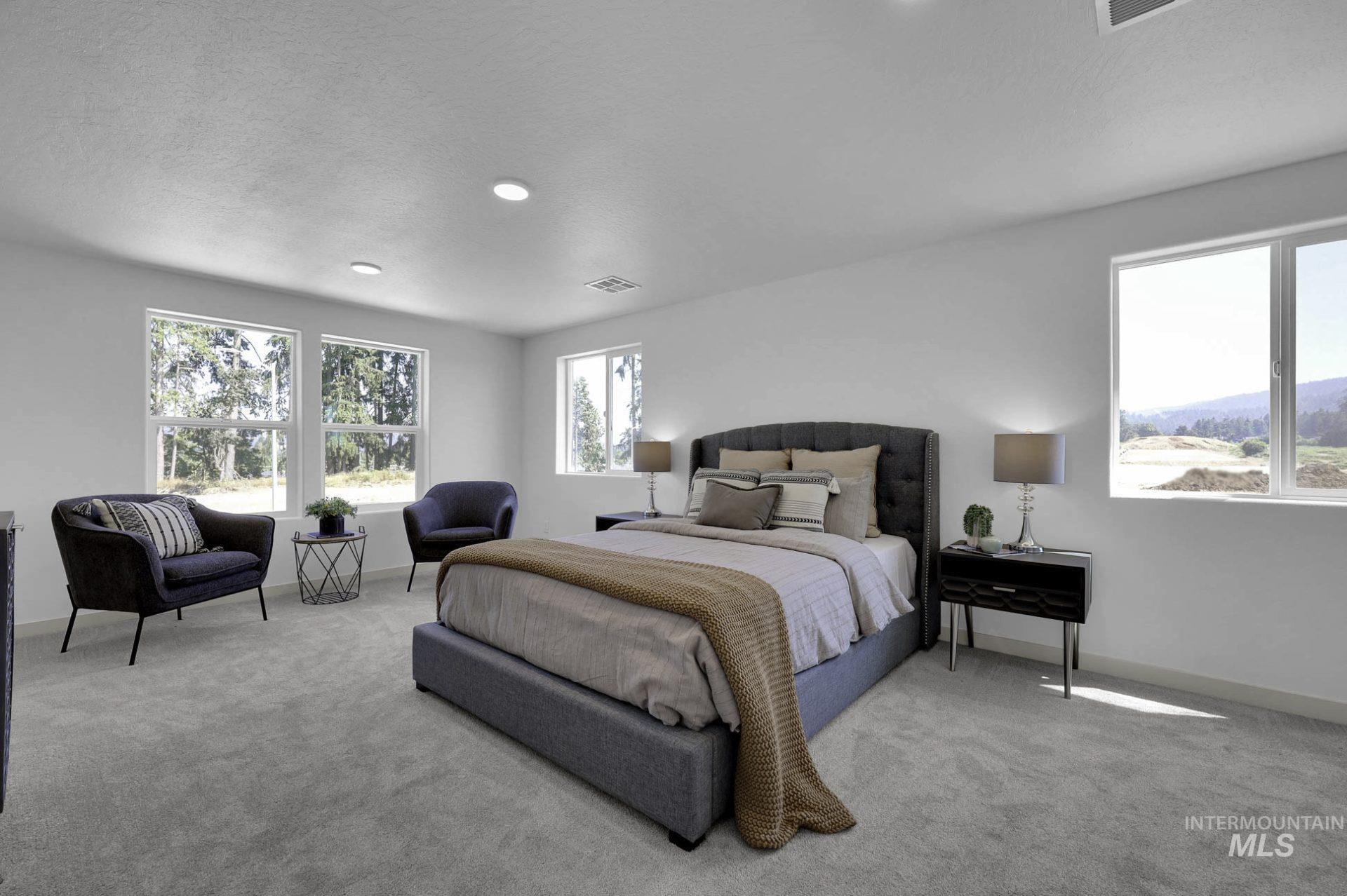 Bedroom with light colored carpet, a textured ceiling, and recessed lighting