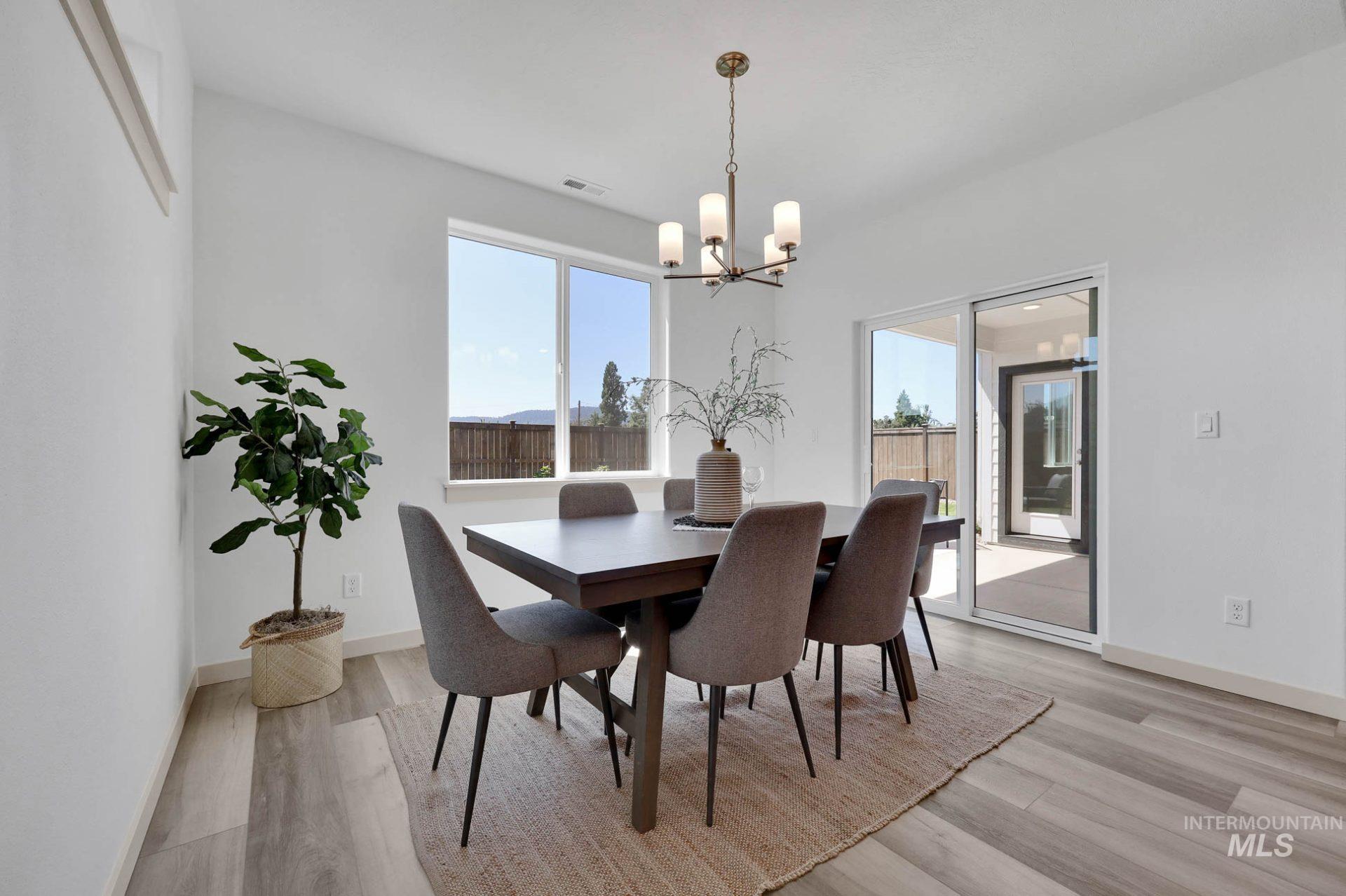 Dining area featuring light wood-style floors and a chandelier