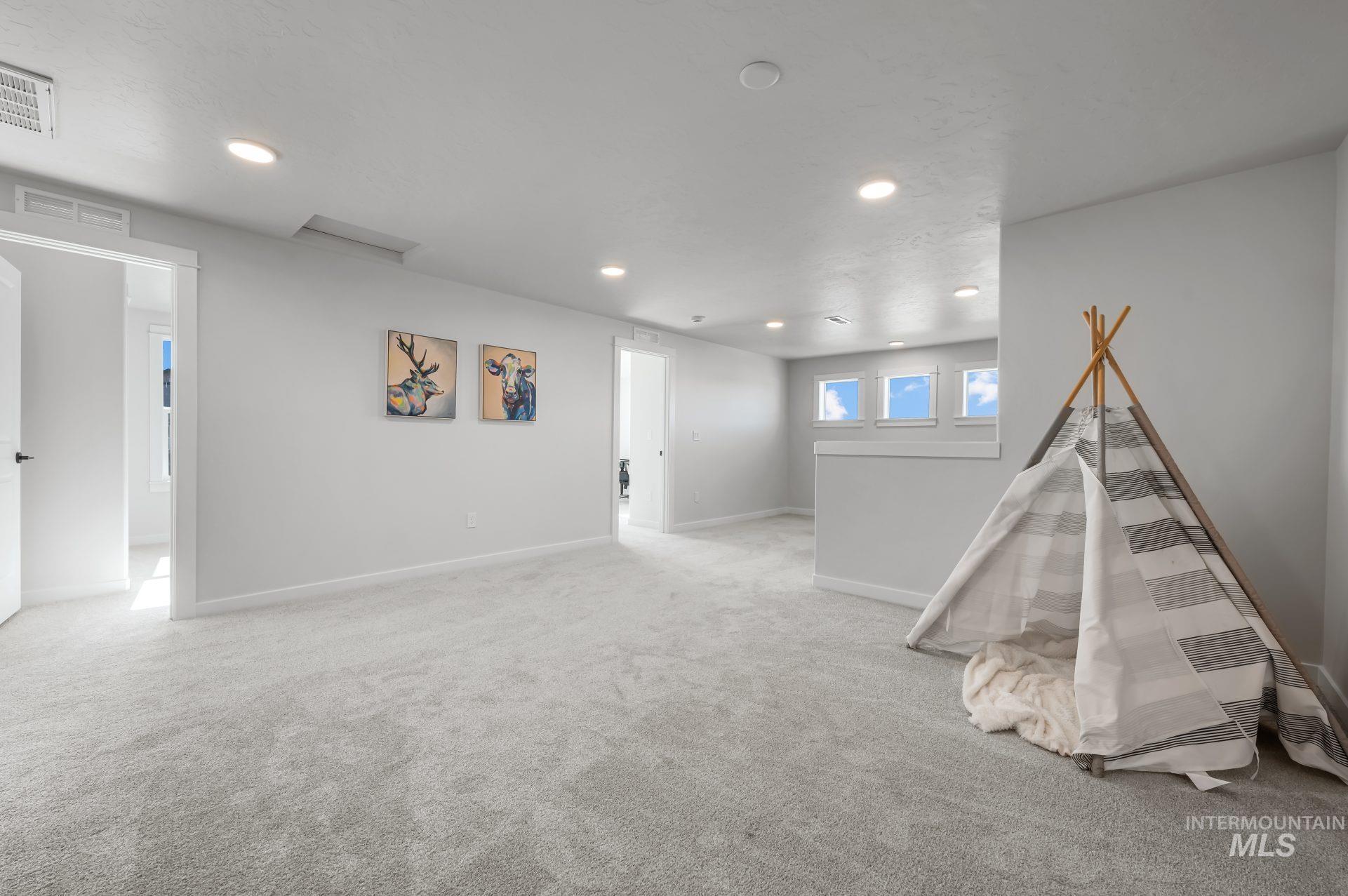 Recreation room with carpet and recessed lighting