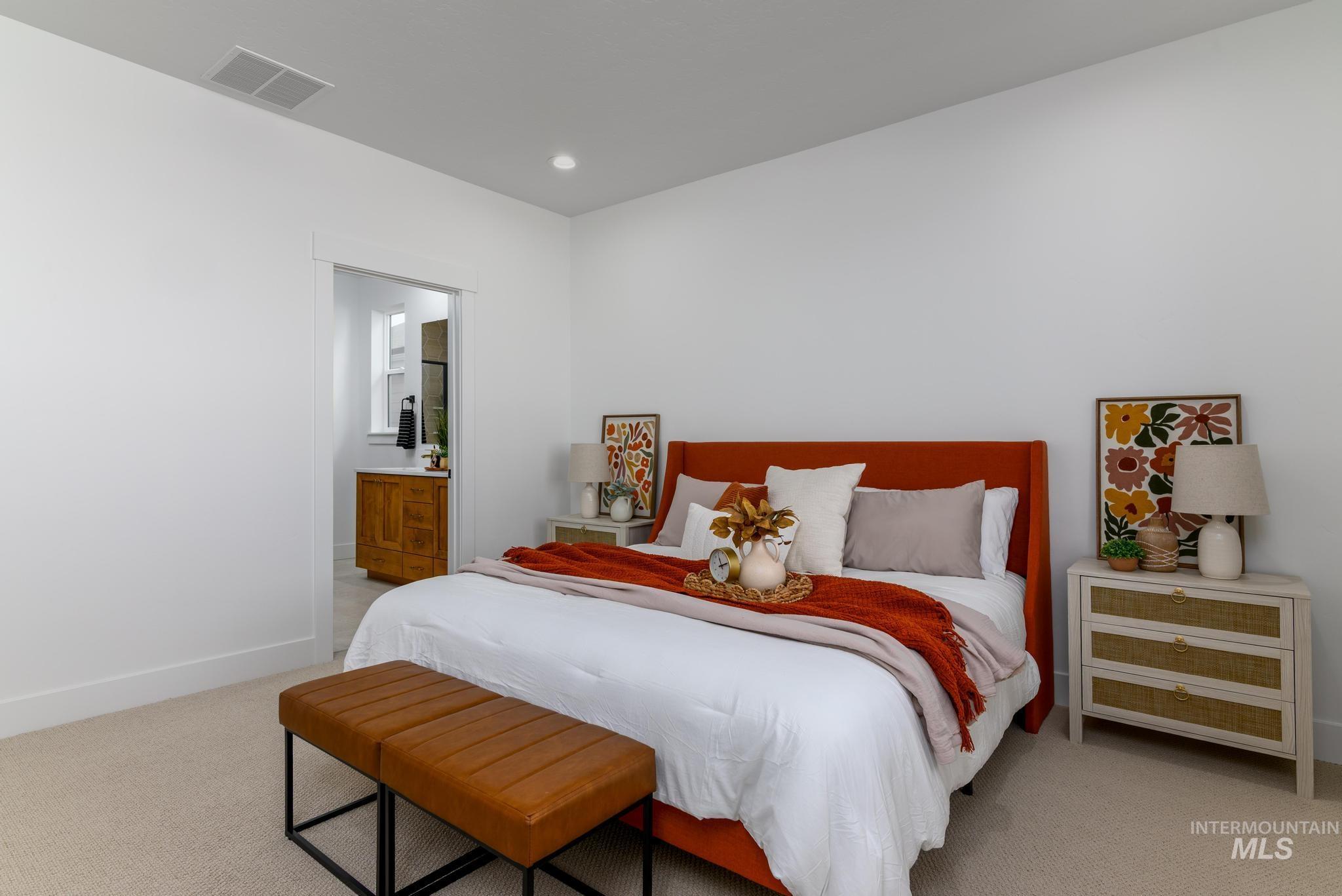 Bedroom with light carpet, recessed lighting, and ensuite bath