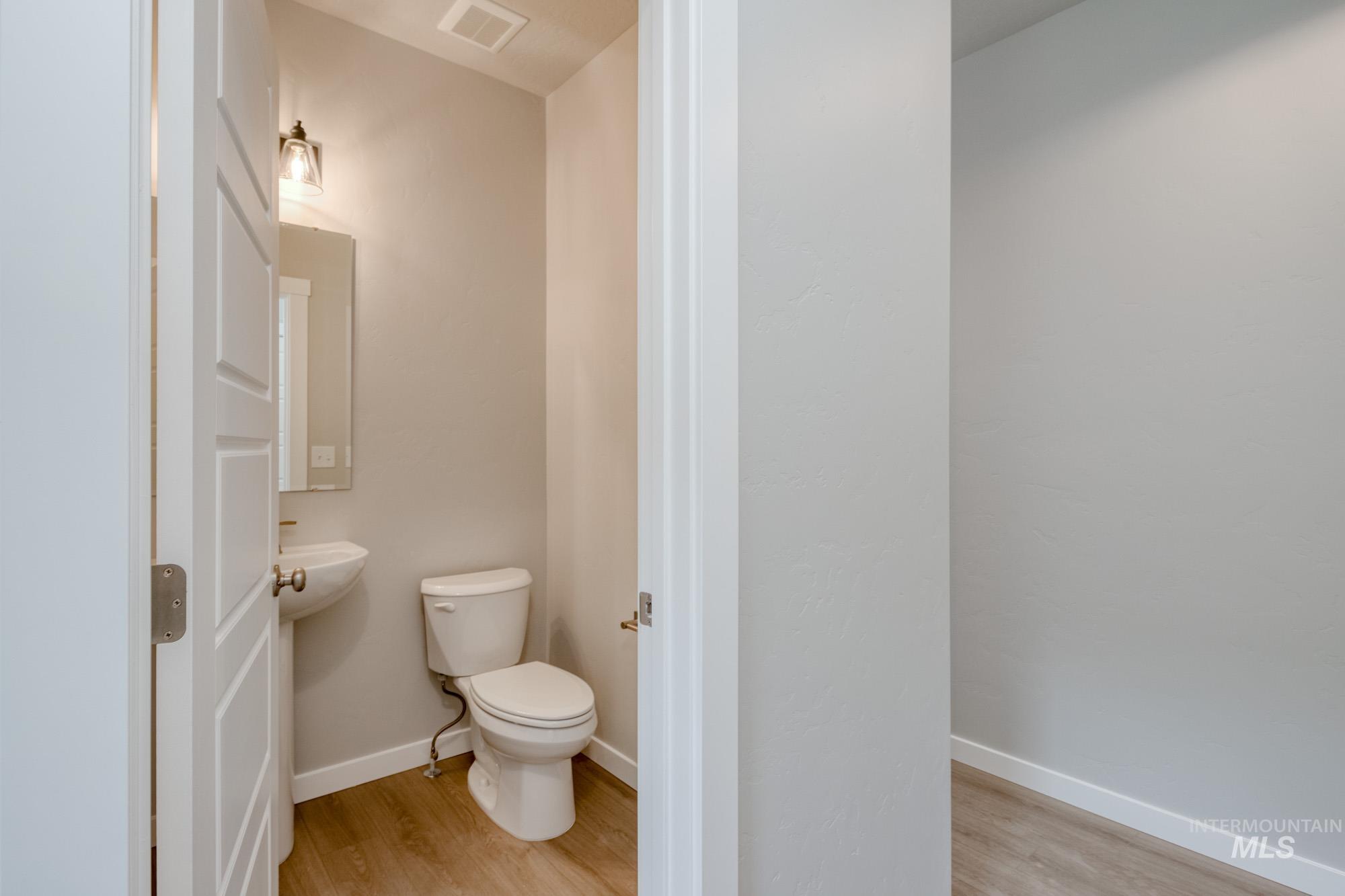 Half bathroom with light wood-style floors