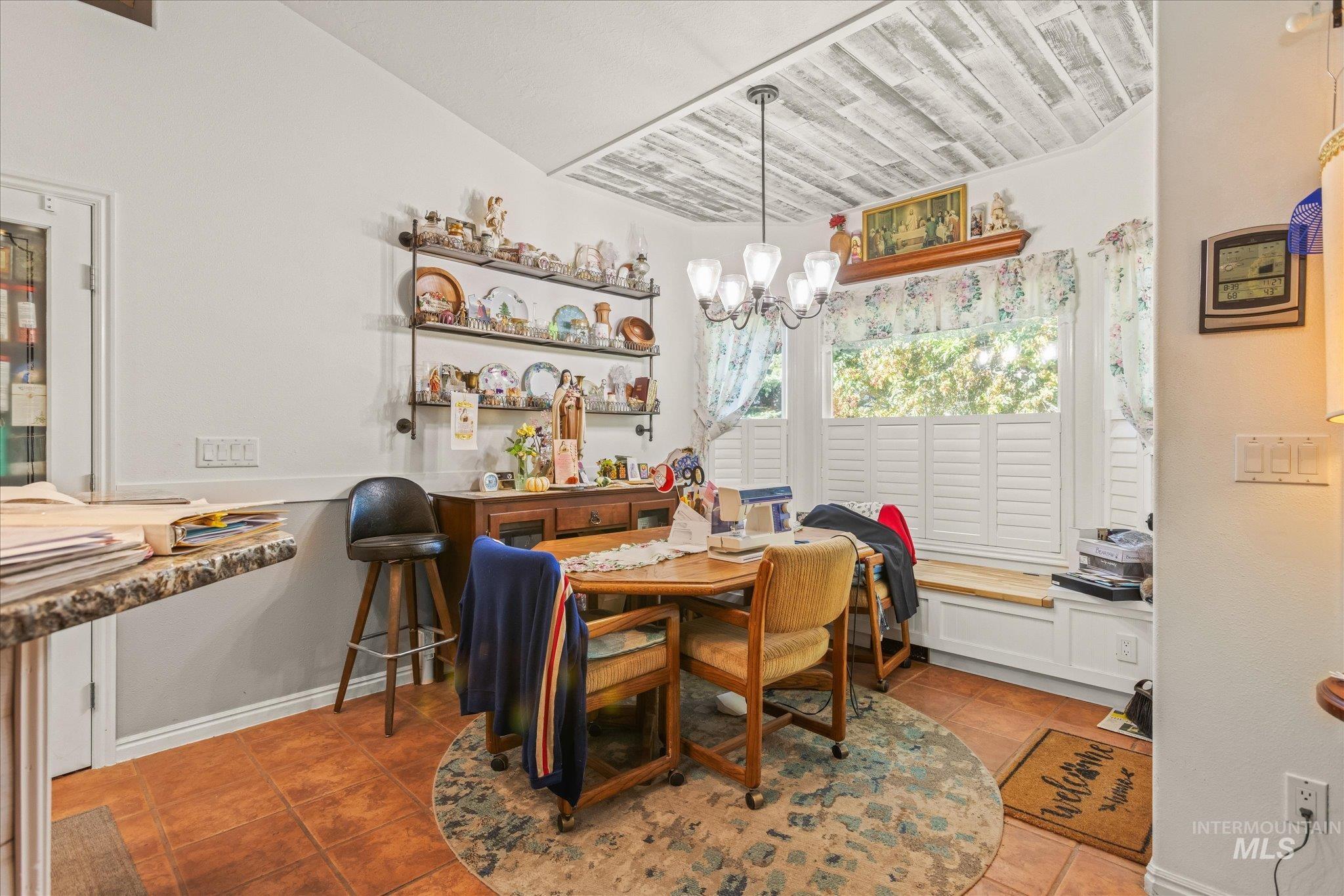 Dining room featuring light tile patterned floors and a chandelier